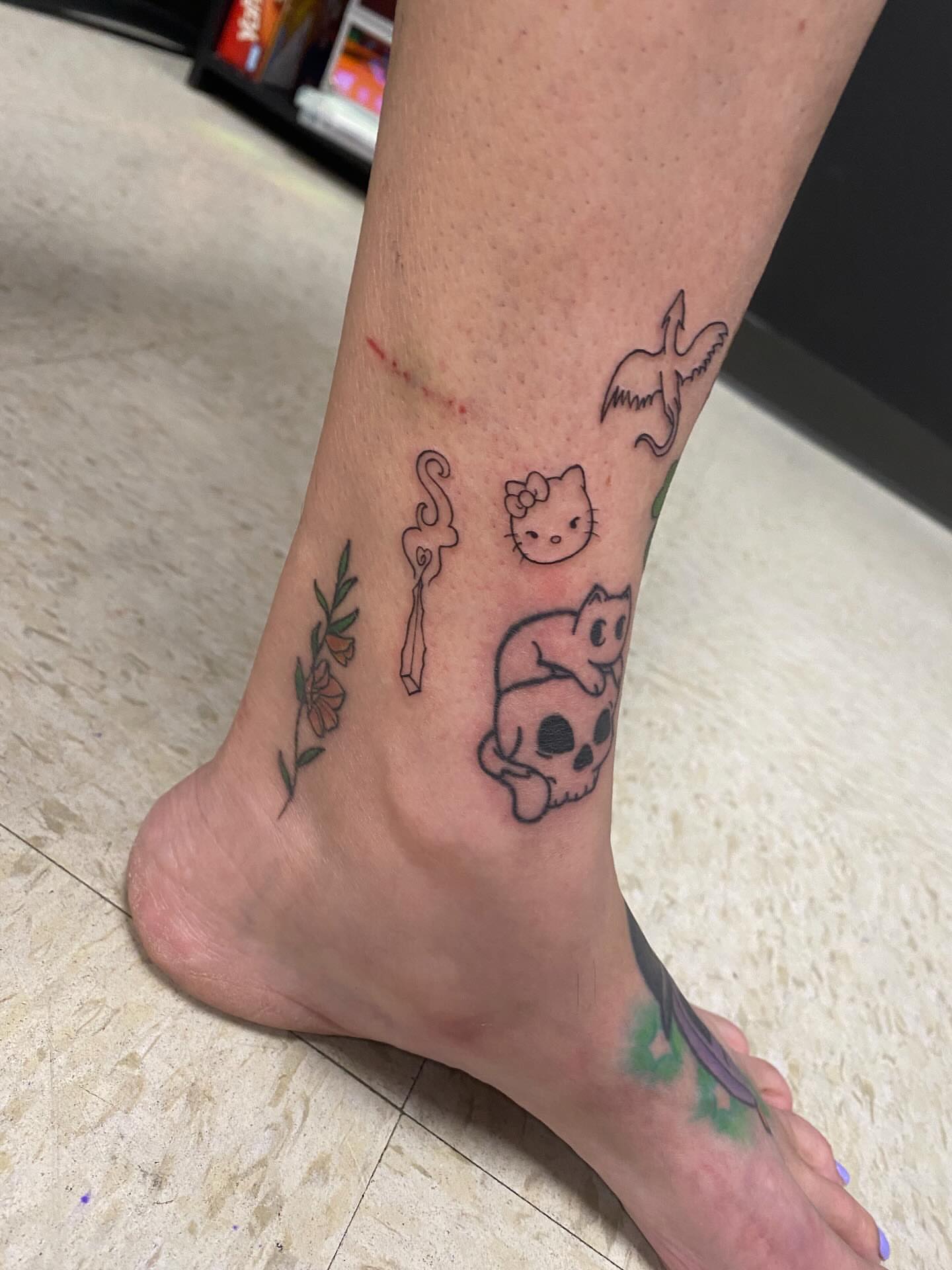 Hello Kitty and pig dotwork tattoo on the foot by Drew