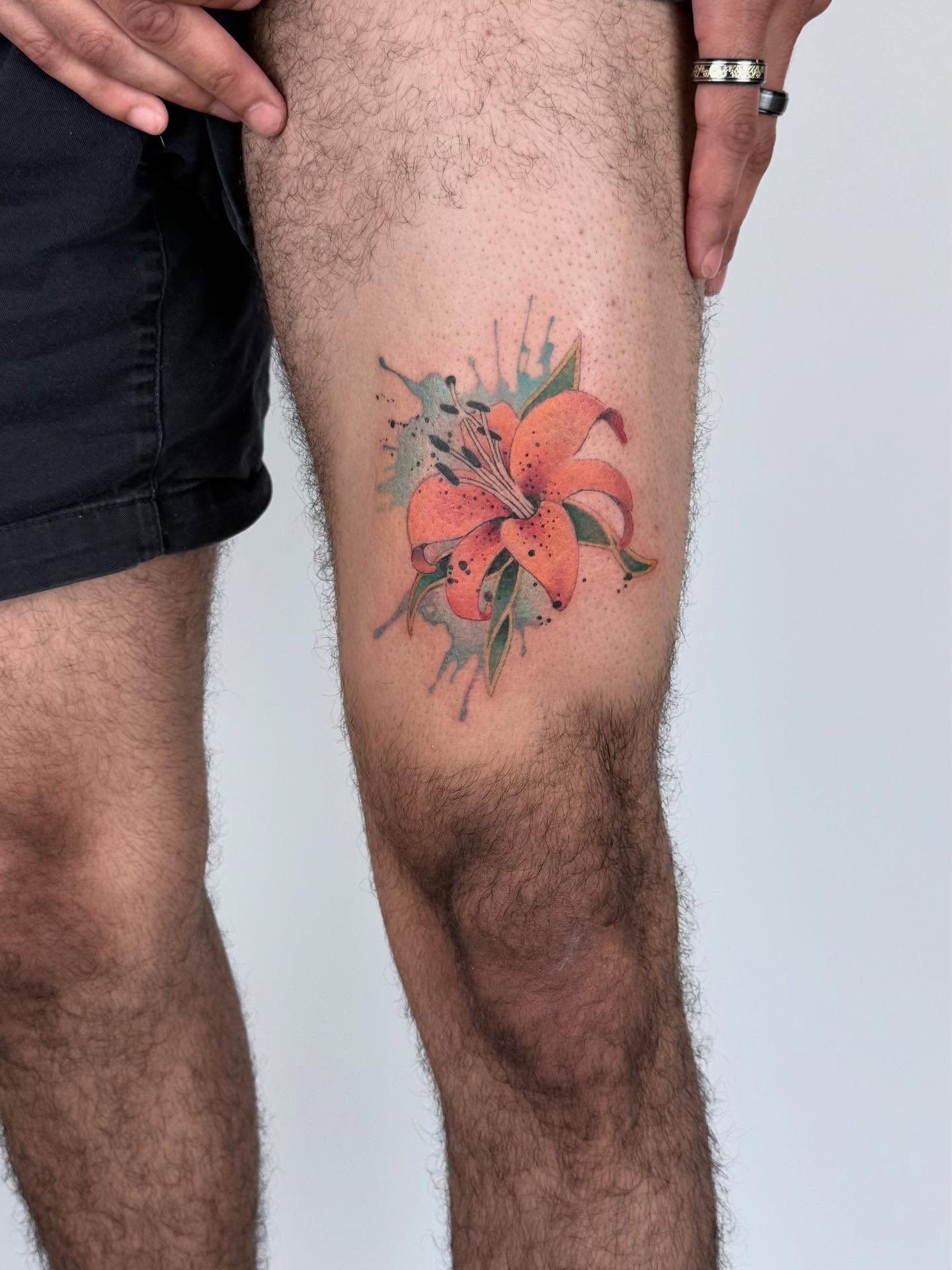 Lily dotwork tattoo on the thigh by Gene Coffey, New York, New York