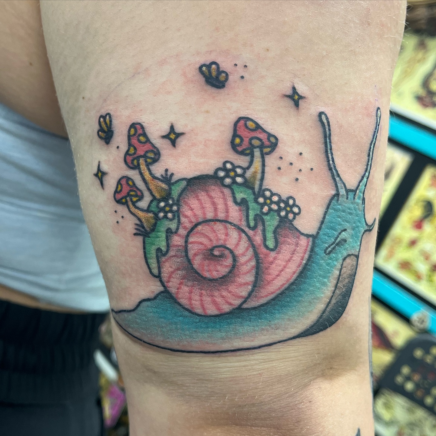 Snail with mushrooms dotwork tattoo on the forearm by Ashley Camp