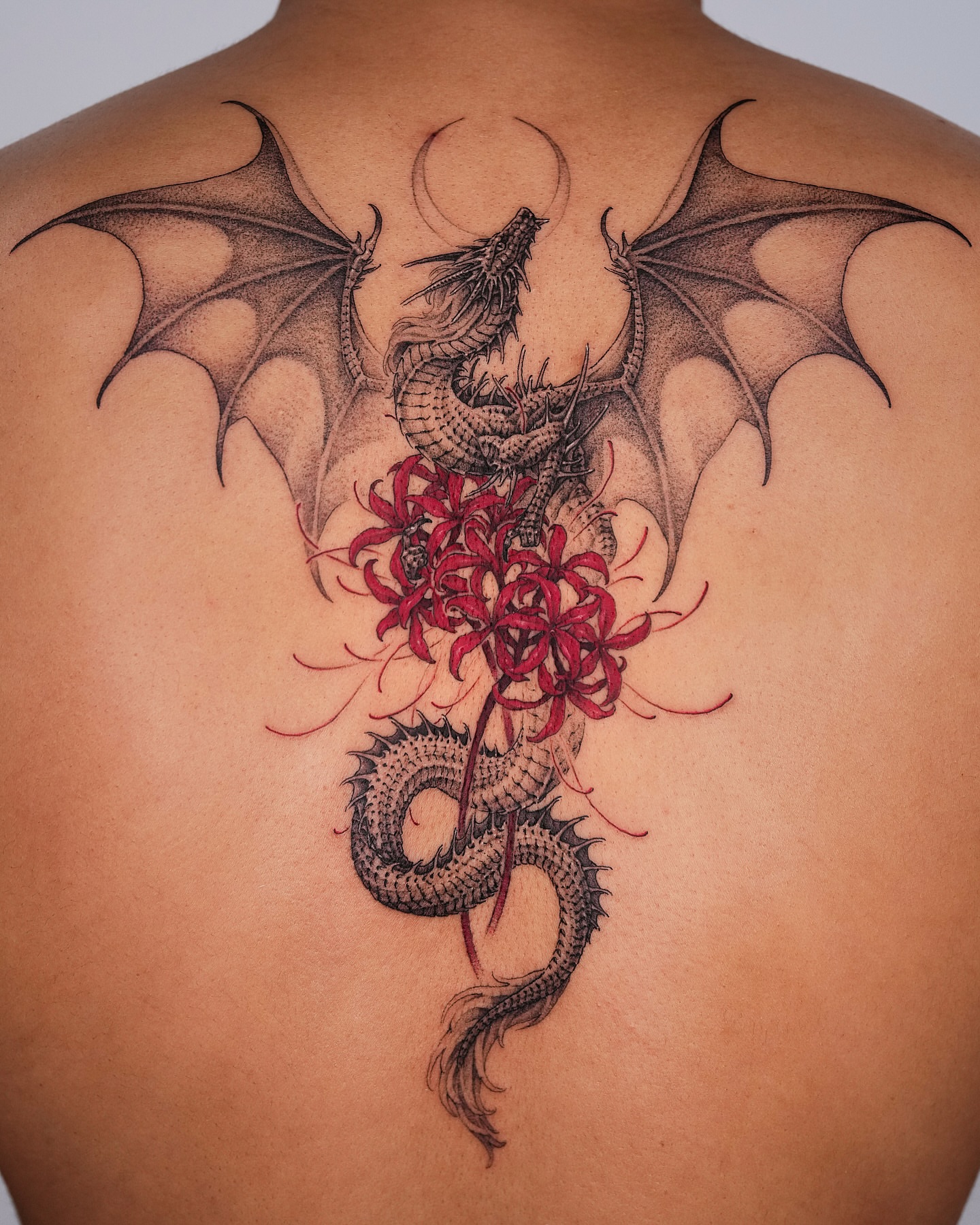 Dragon and flowers realism tattoo on the back by Intat