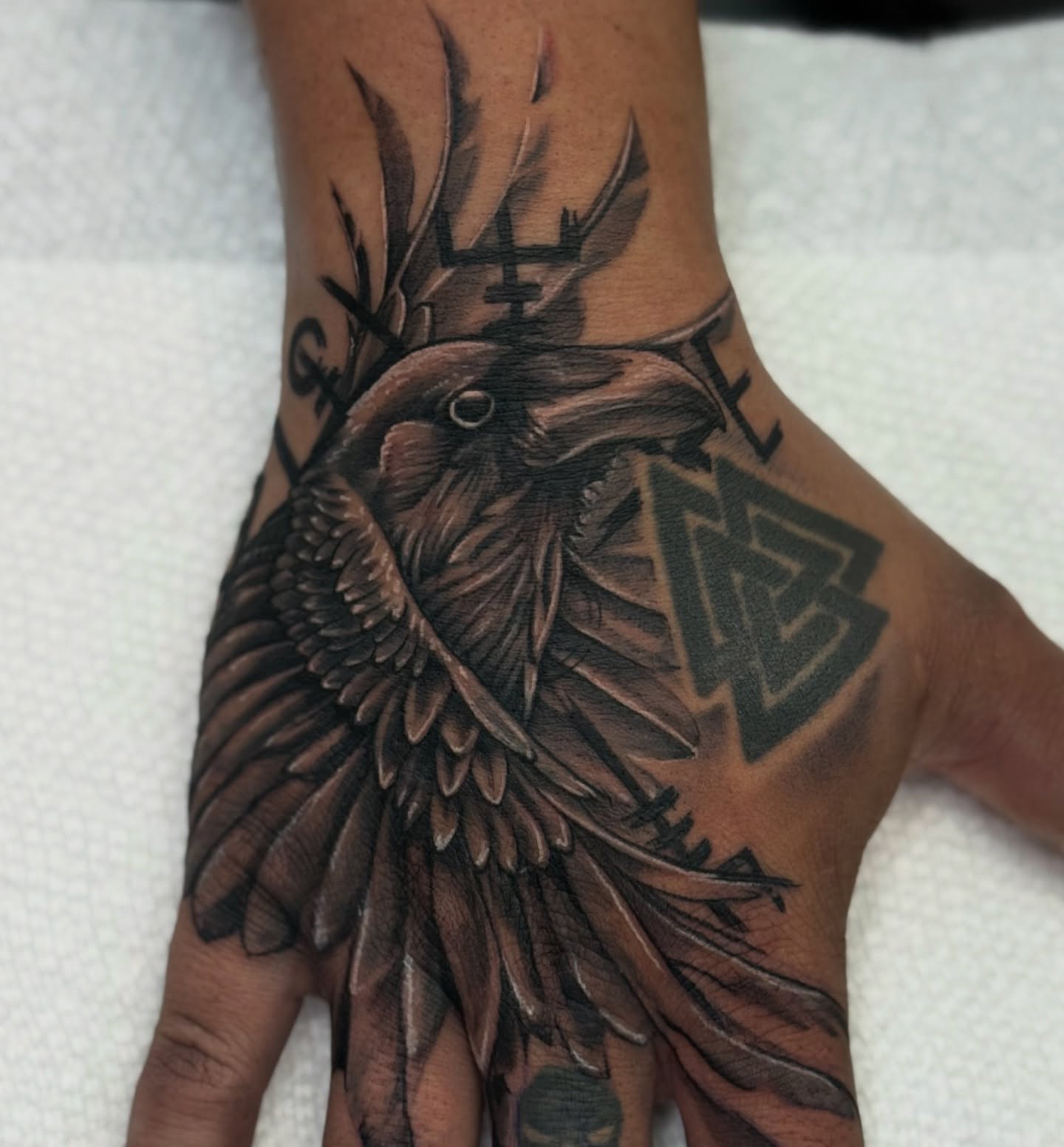 Crow realism tattoo on the hand by Indiana Tattoo Artist