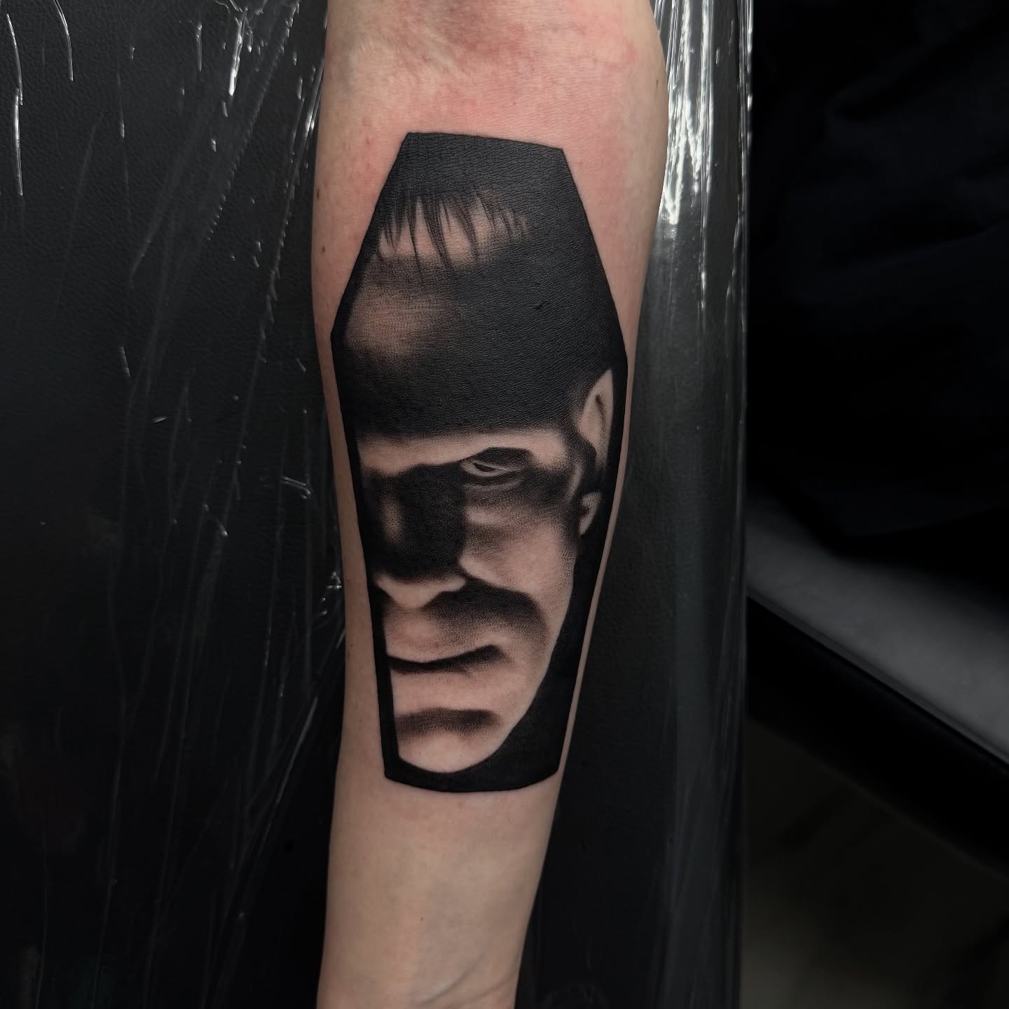 Man's face realism tattoo on the forearm by Nick Campbell