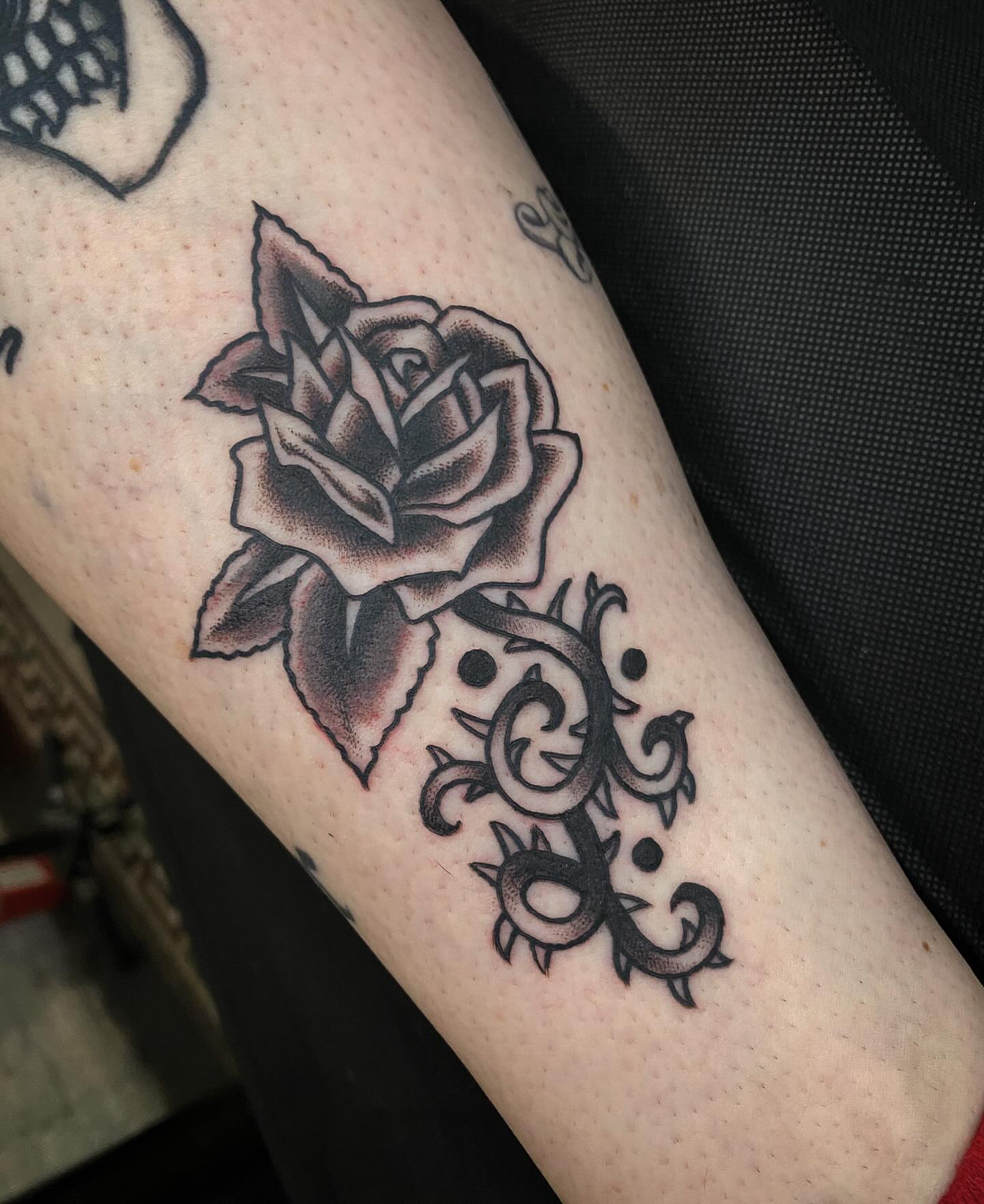 Rose black and grey tattoo on the forearm by Morgana Sutherland