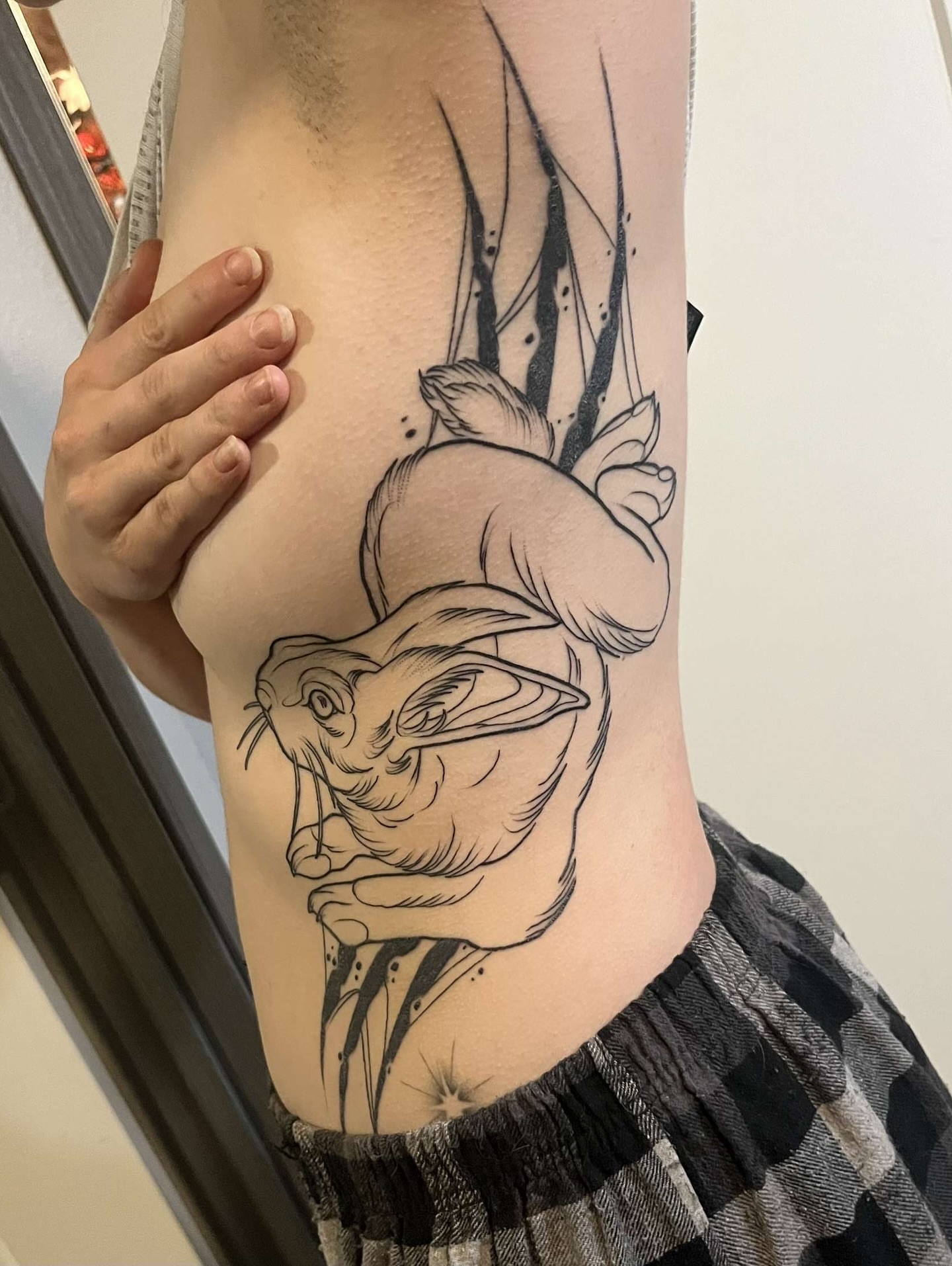 Rabbit black and grey tattoo on the ribs by BodyArtByAlia