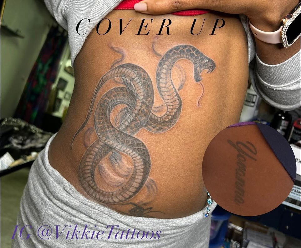 Snake black and grey tattoo on the ribs by Victoria Mendez