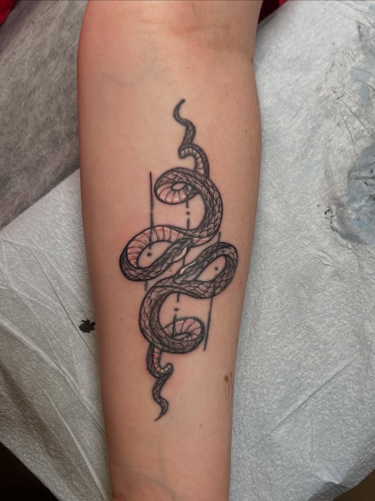Snake black and grey tattoo on the forearm by sarah bug