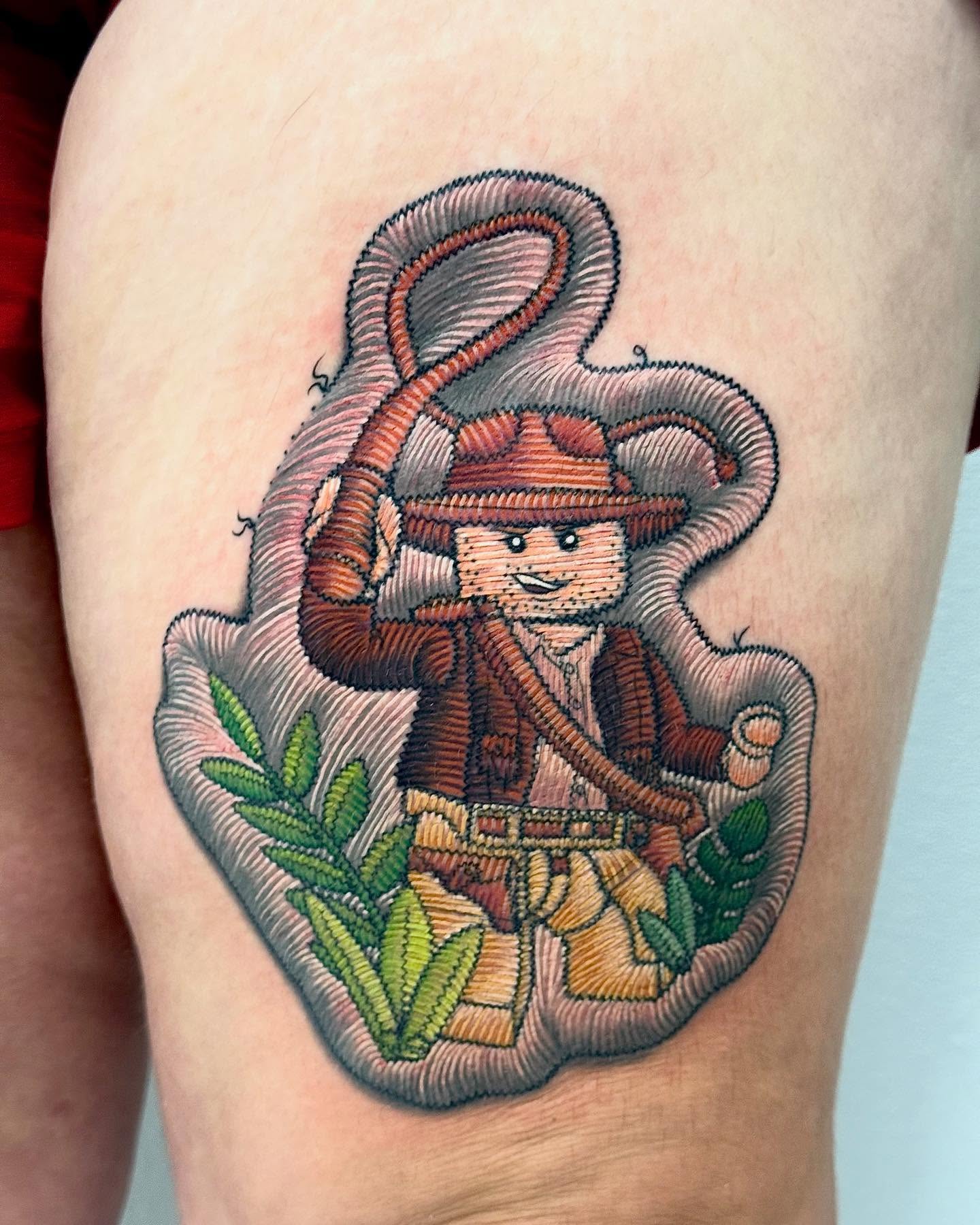 Explorer with whip realism tattoo on the thigh by Lacee-Beth Finch