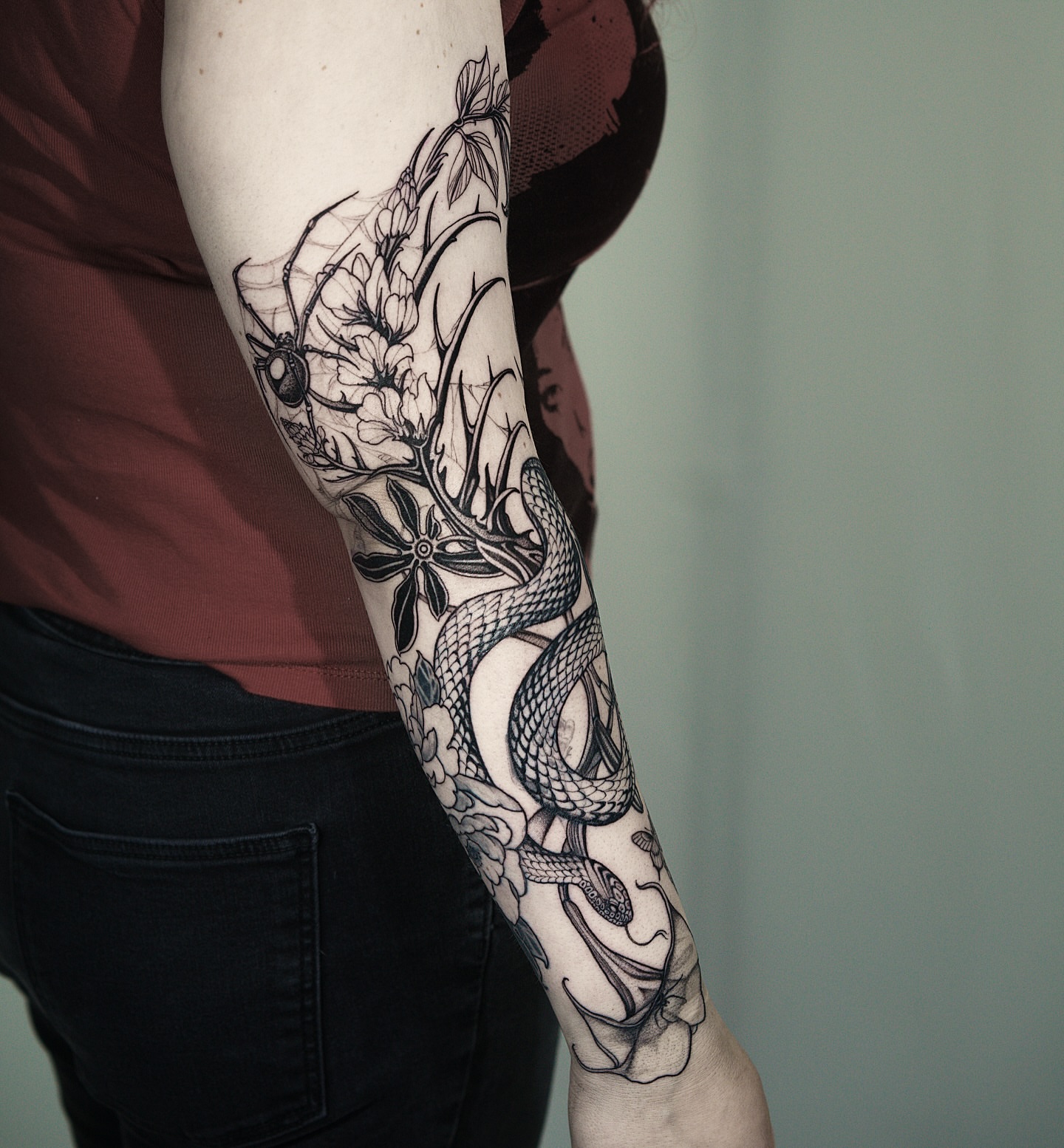 Snake and flowers black and grey tattoo on the forearm by H I R A  L U P E - tattoo artist, Oakland, California