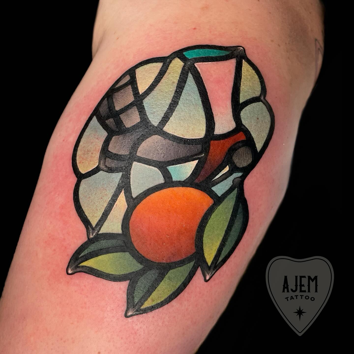 Stained glass window geometric tattoo on the forearm by Ash MacIsaac