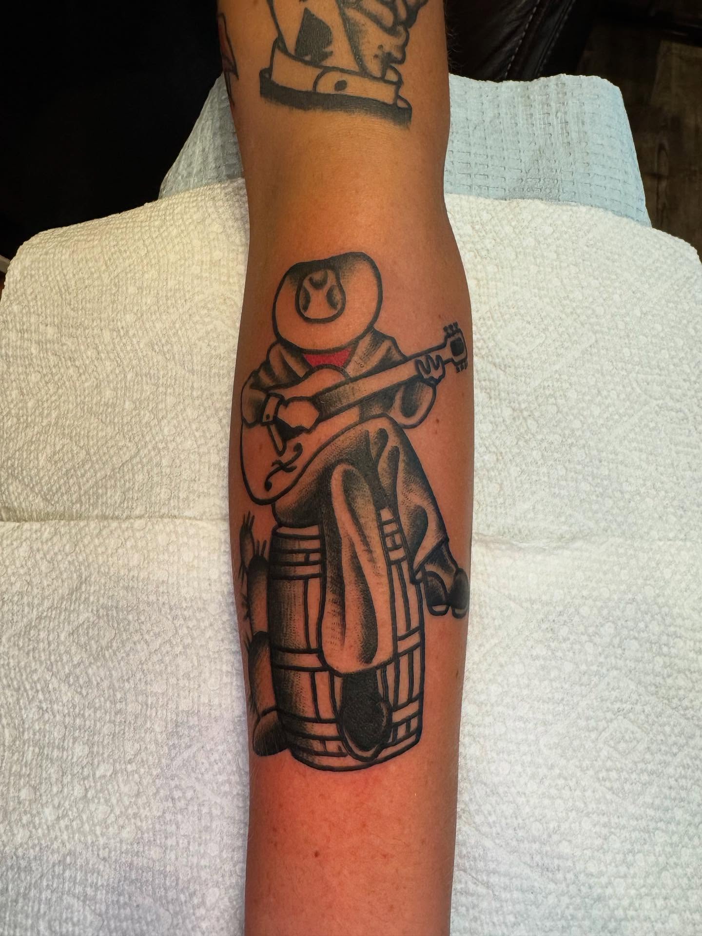 Guitarist black and grey tattoo on the forearm by Rob Keiuf