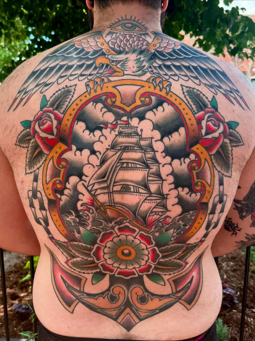 Ship, eagle, anchor, and roses American traditional tattoo on the back by Ryan Moraski, Colorado Springs, Colorado