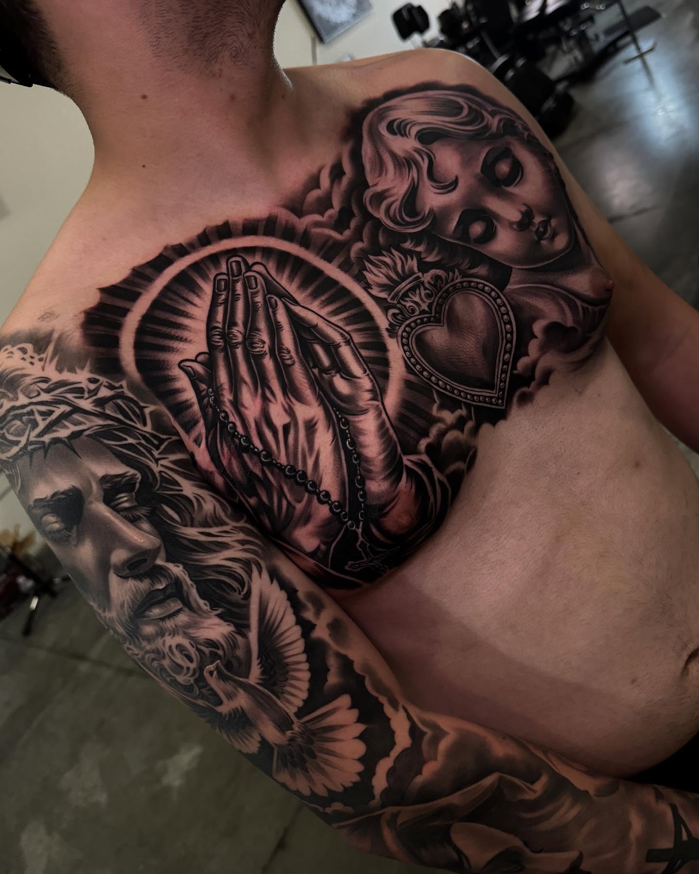 Praying hands with heart realism tattoo on the chest by eksoe_