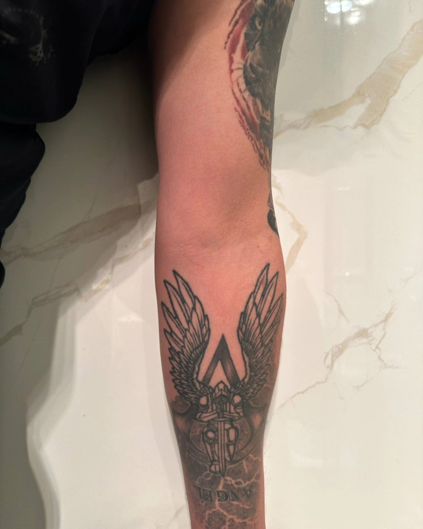 Winged sword black and grey tattoo on the forearm by danha_seoul tattooist