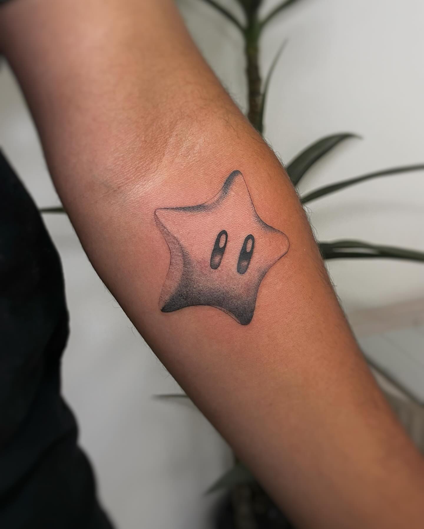 Star black and grey tattoo on the forearm by David