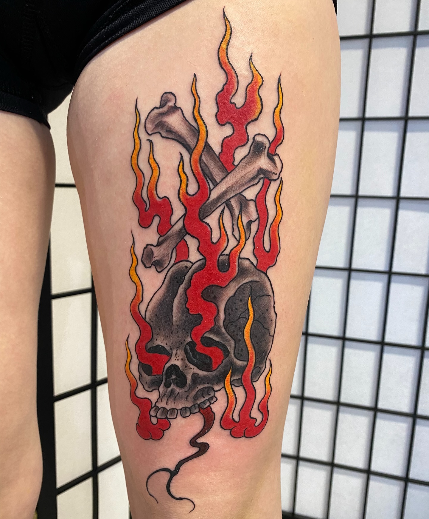 Flaming skull dotwork tattoo on the thigh by John Black