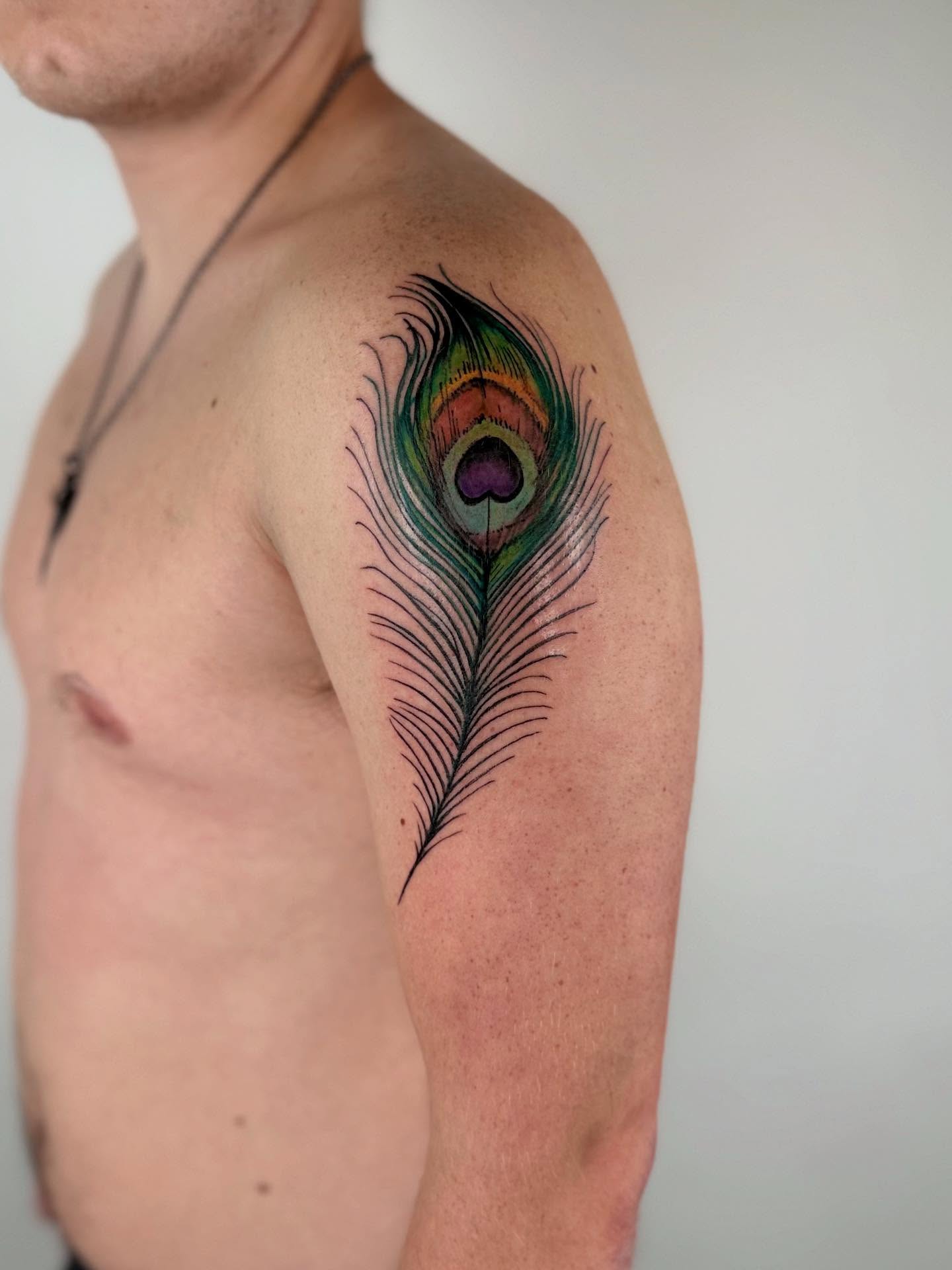Peacock feather realism tattoo on the shoulder by Gene Coffey, New York, New York