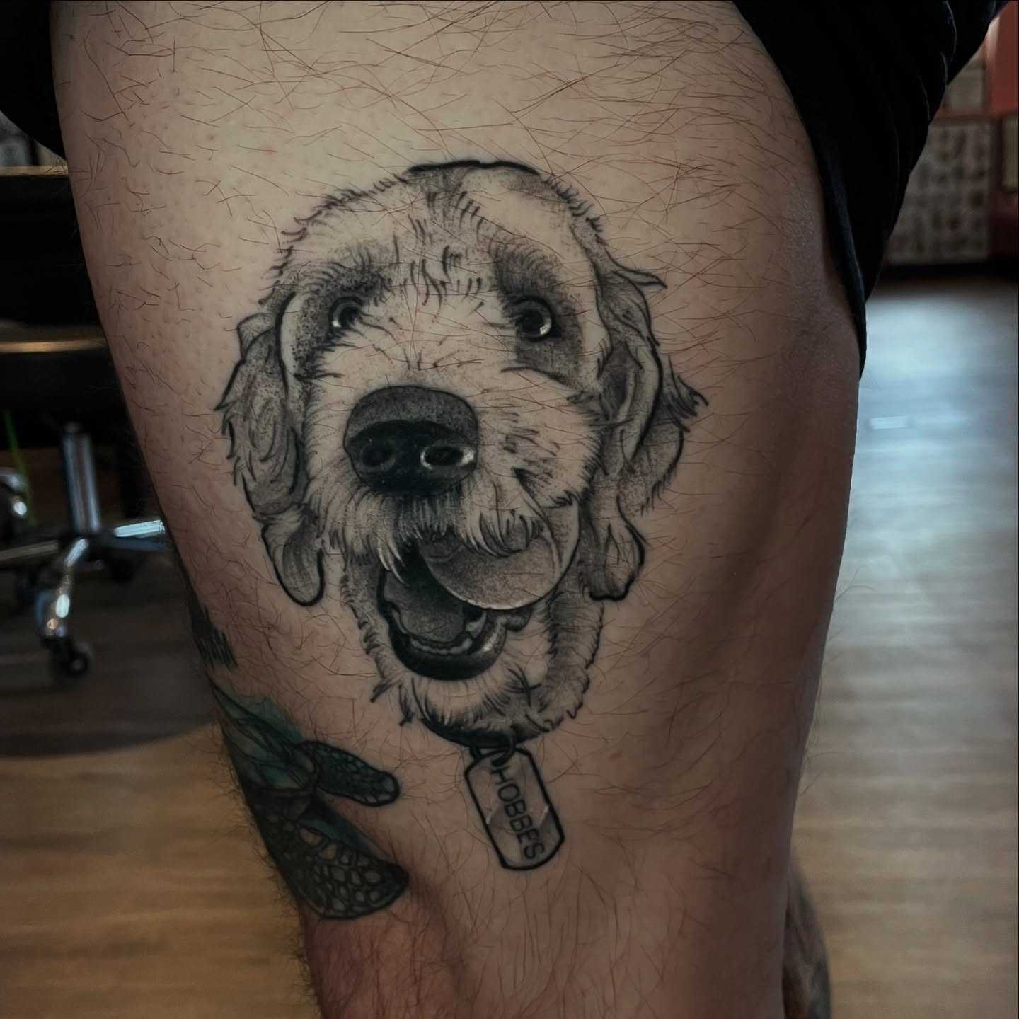 Dog realism tattoo on the thigh by Ian Spong