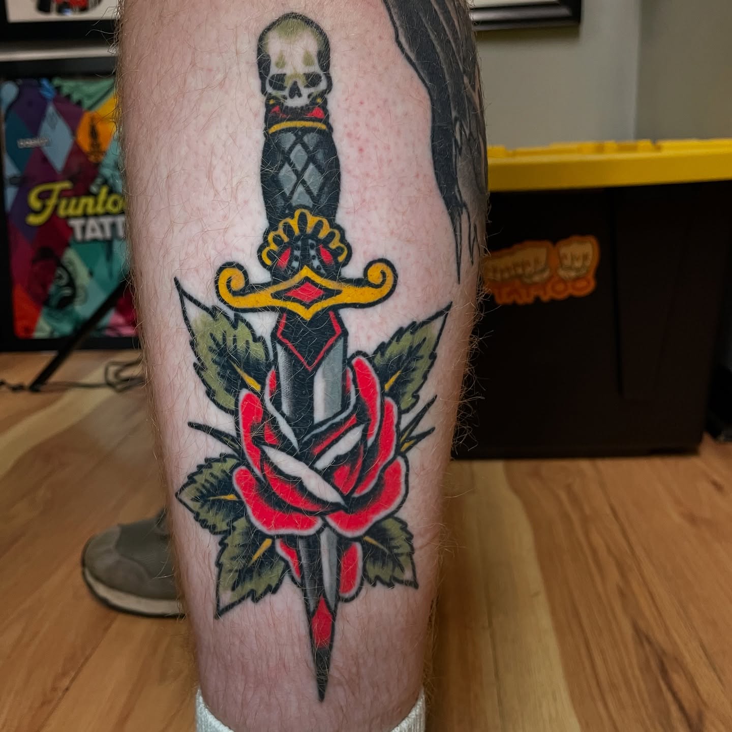 Knife and rose American traditional tattoo on the forearm by Ian Spong