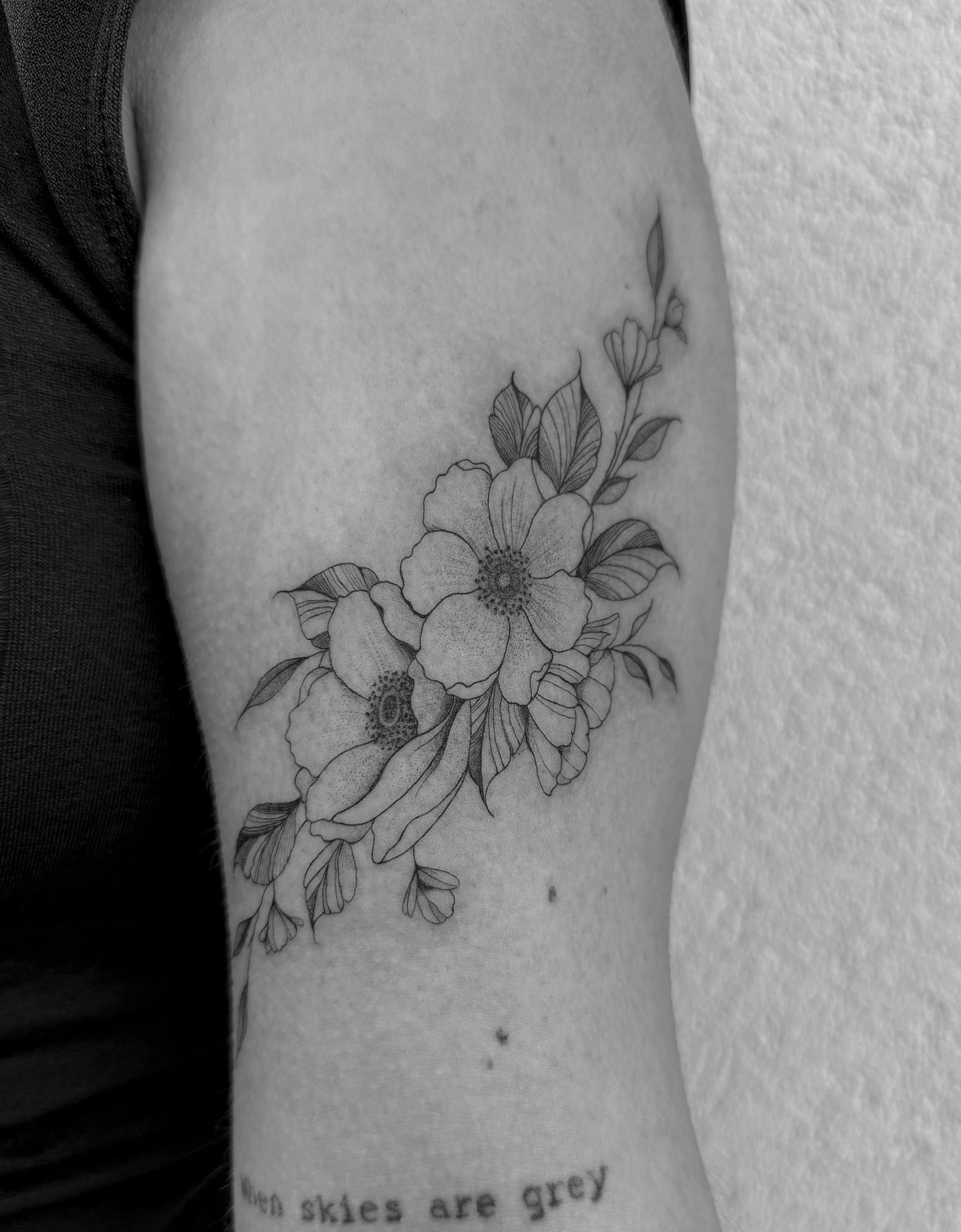 Floral bouquet black and grey tattoo on the forearm by Abby Robinson