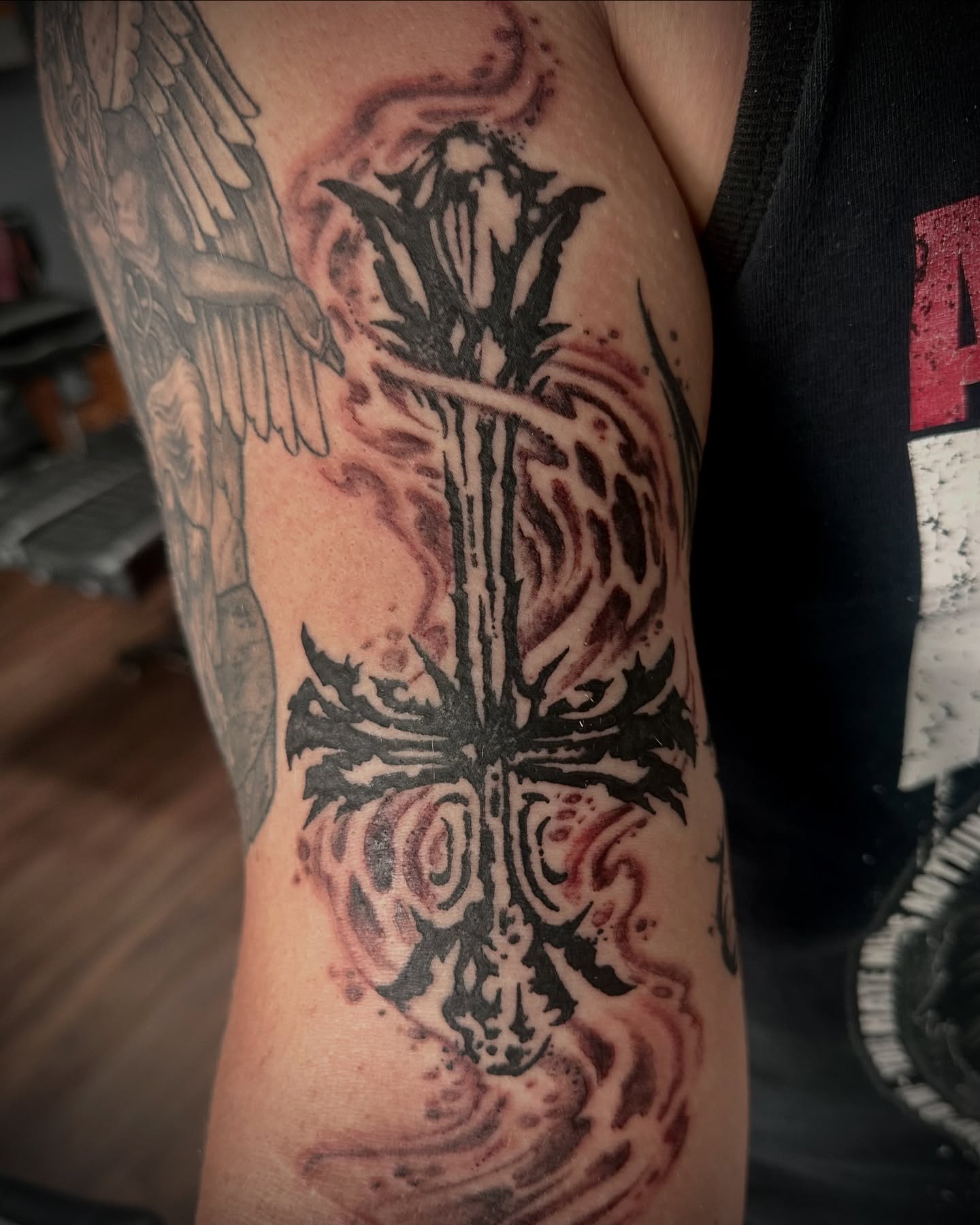 Cross with flames dark realism tattoo on the forearm by Culleton Paramore
