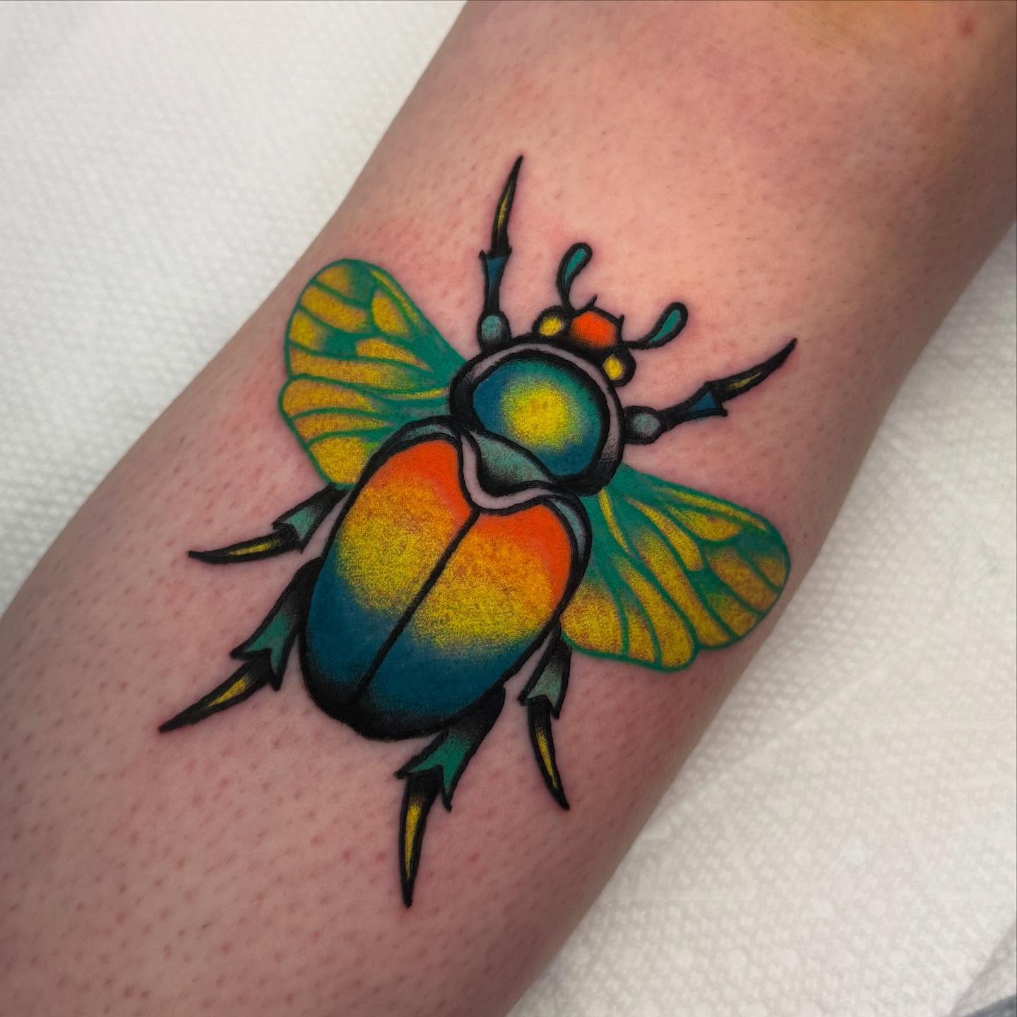 Beetle American traditional tattoo on the forearm by Shana