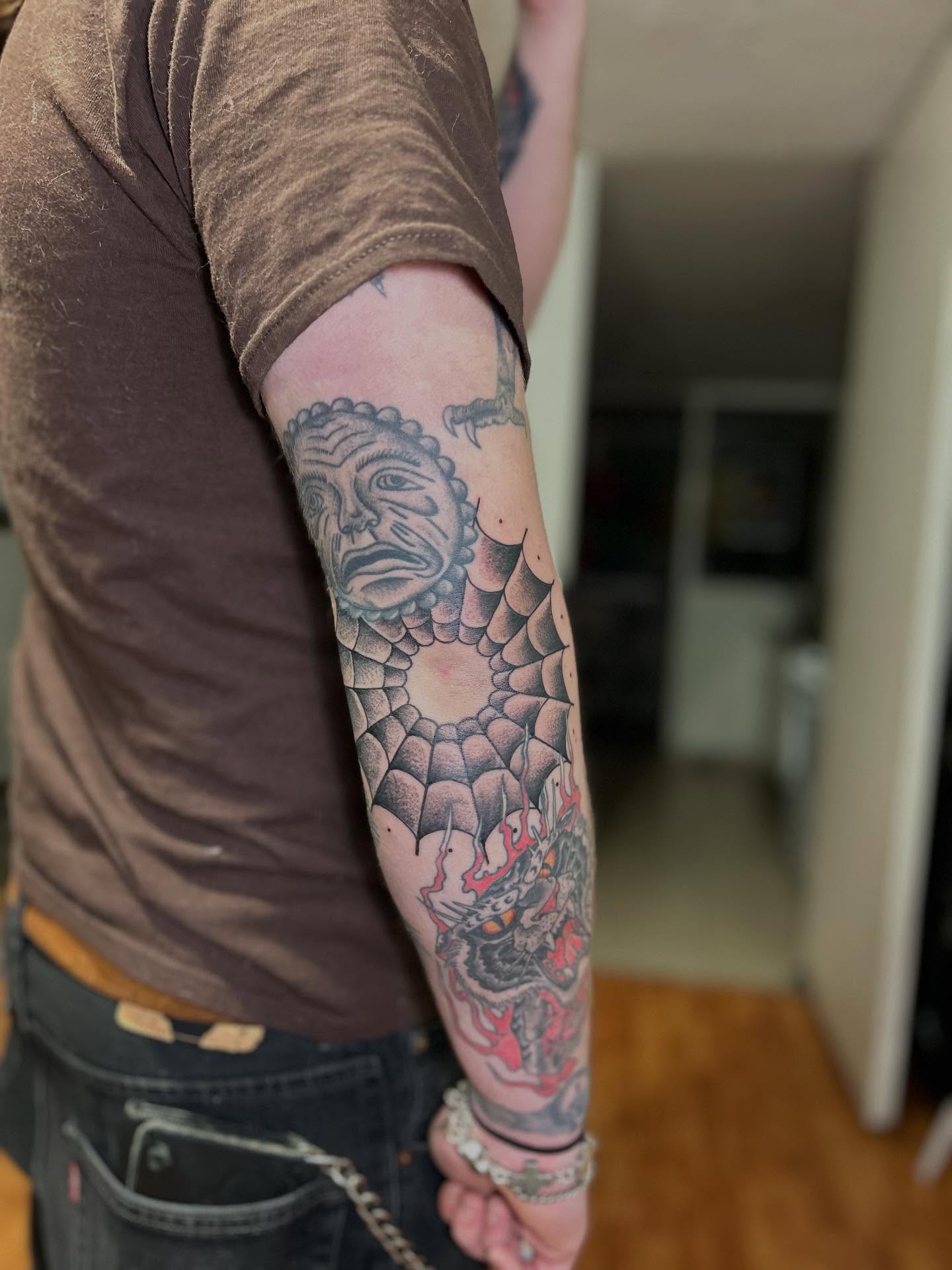Mask and dragon dotwork tattoo on the forearm by Barro