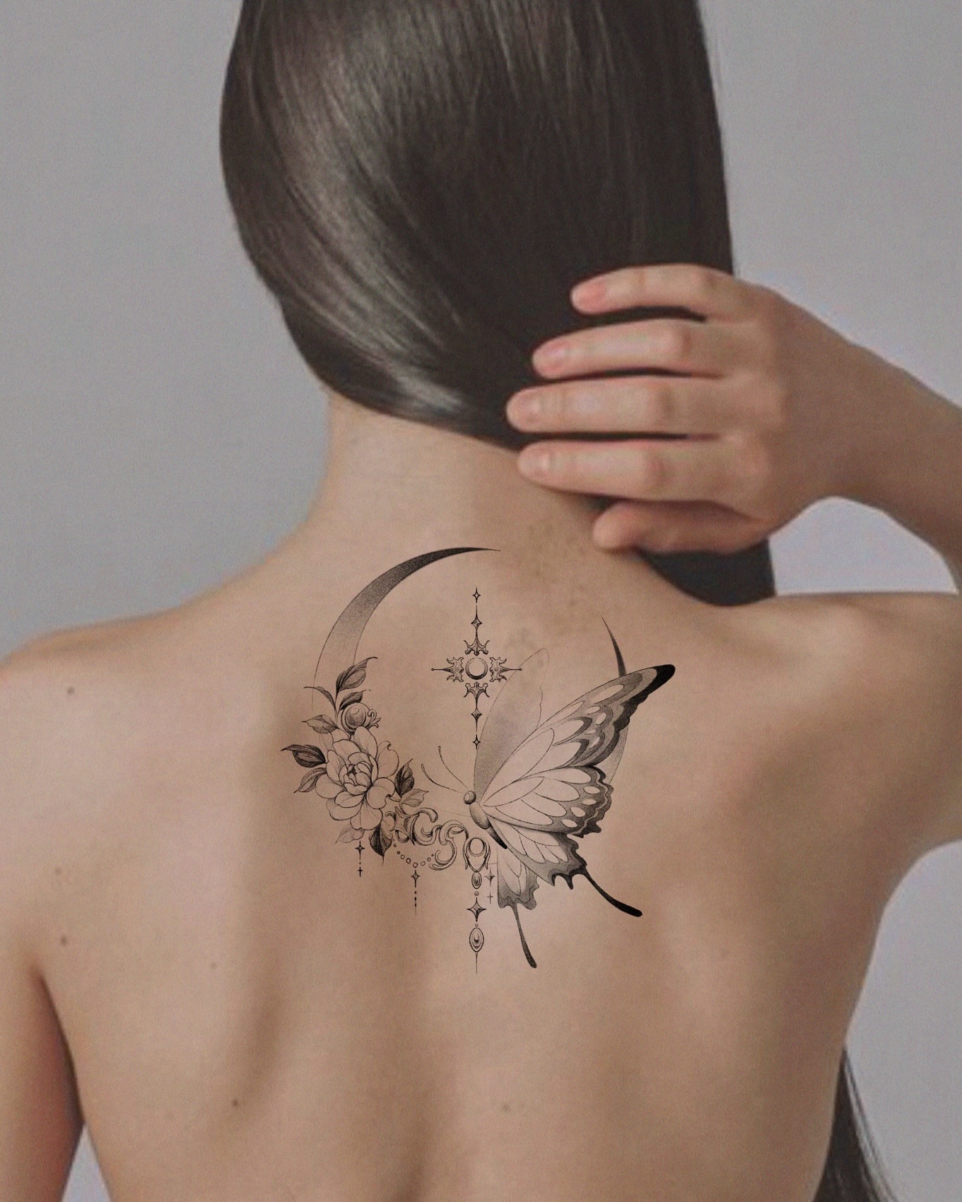 Butterfly and crescent moon geometric tattoo on the back by Yeonji