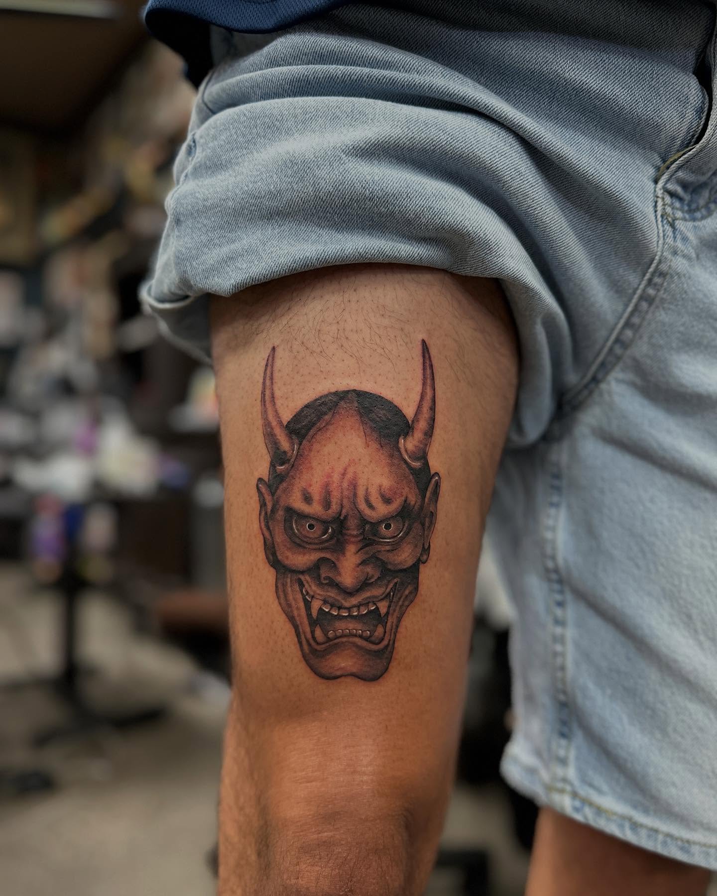 Demon face realism tattoo on the thigh by Shawn Feng