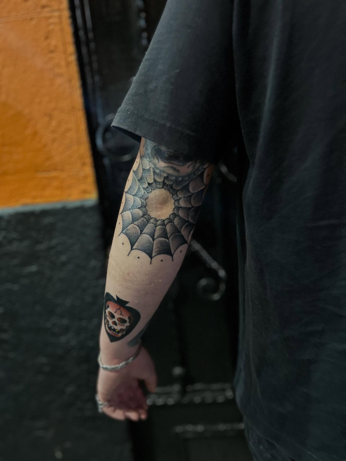 Spider web dotwork tattoo on the forearm by Barro