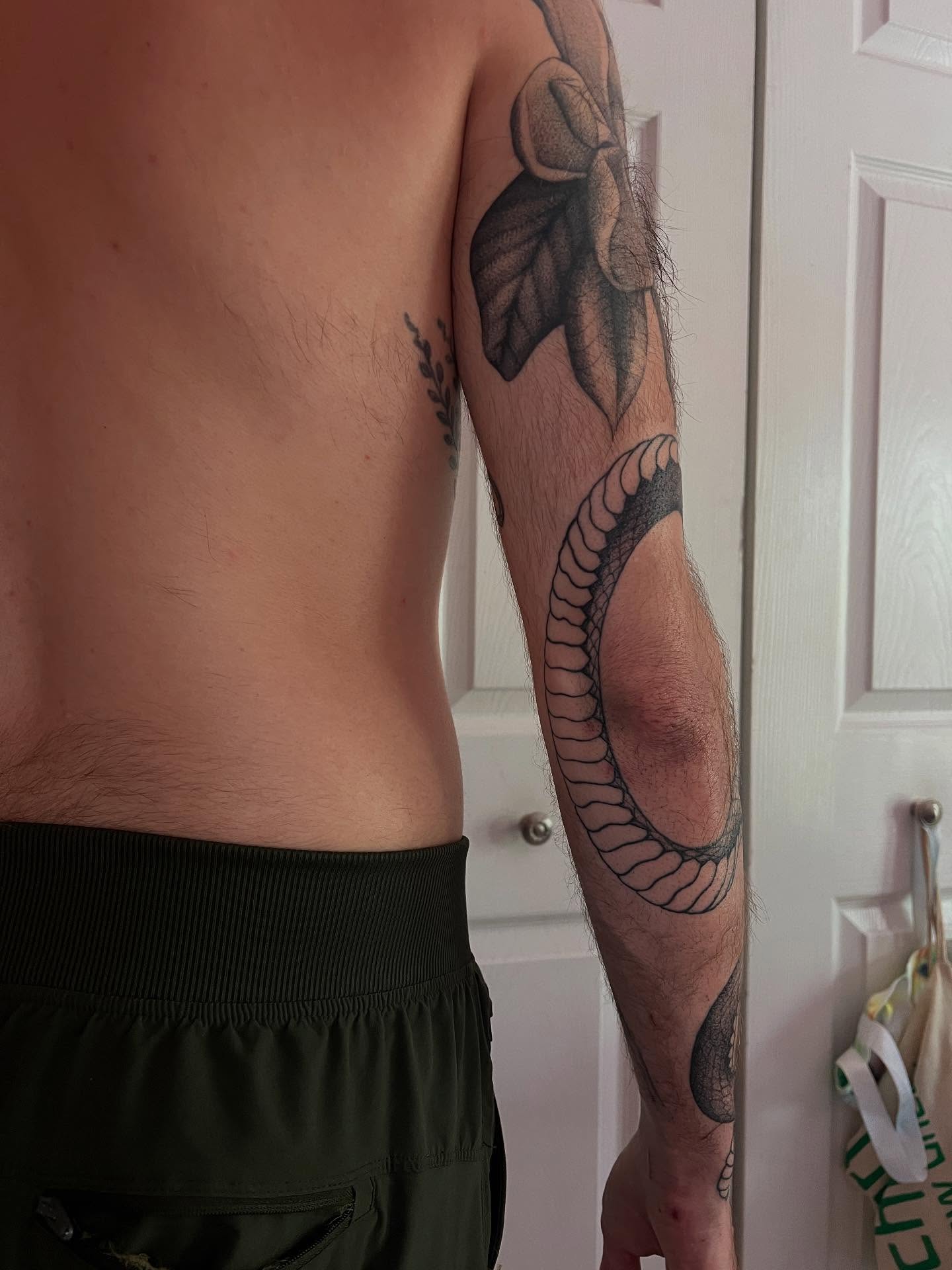 Snake black and grey tattoo on the upper arm by Natasha