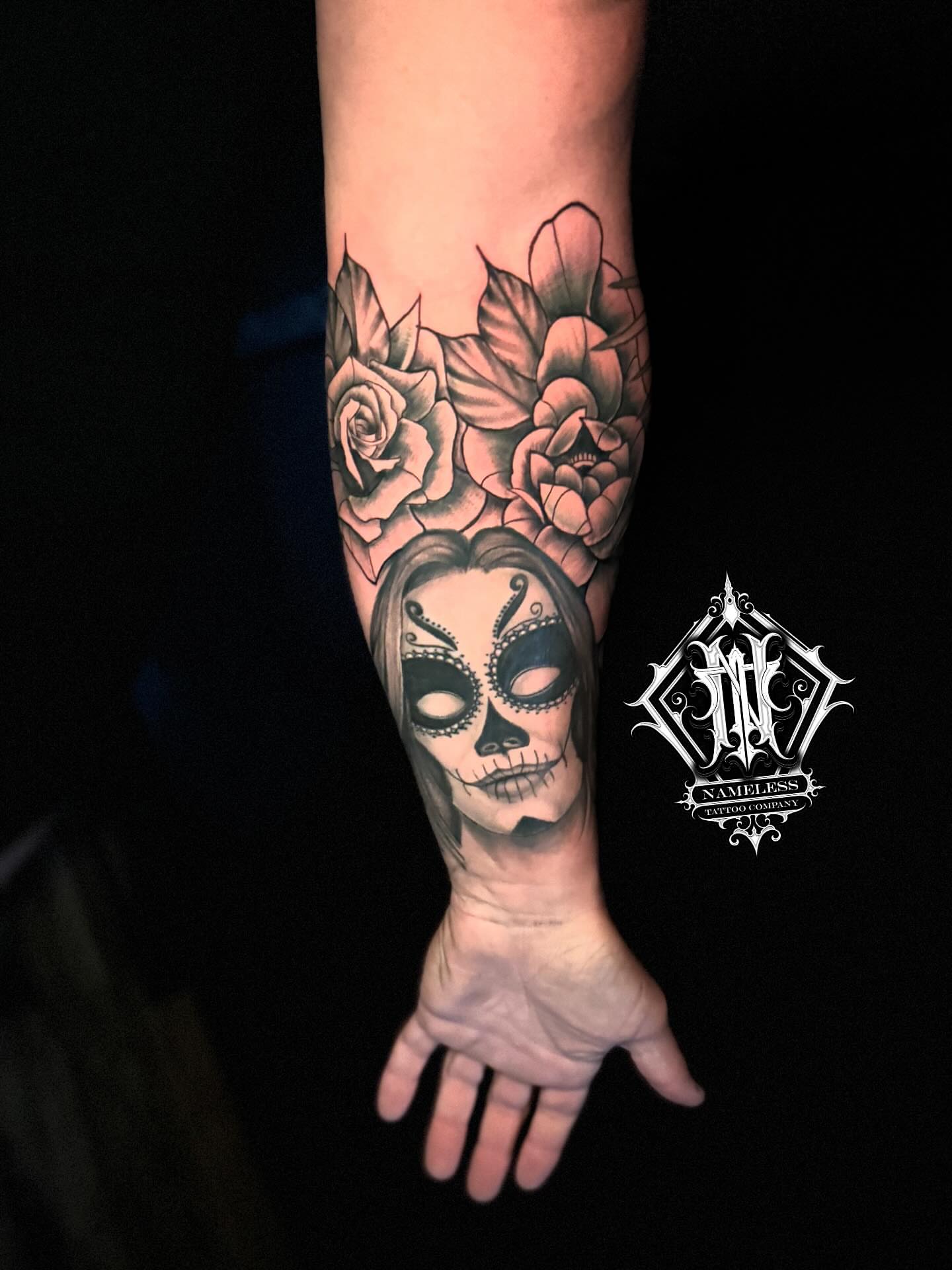 Sugar skull with roses realism tattoo on the forearm by AJ