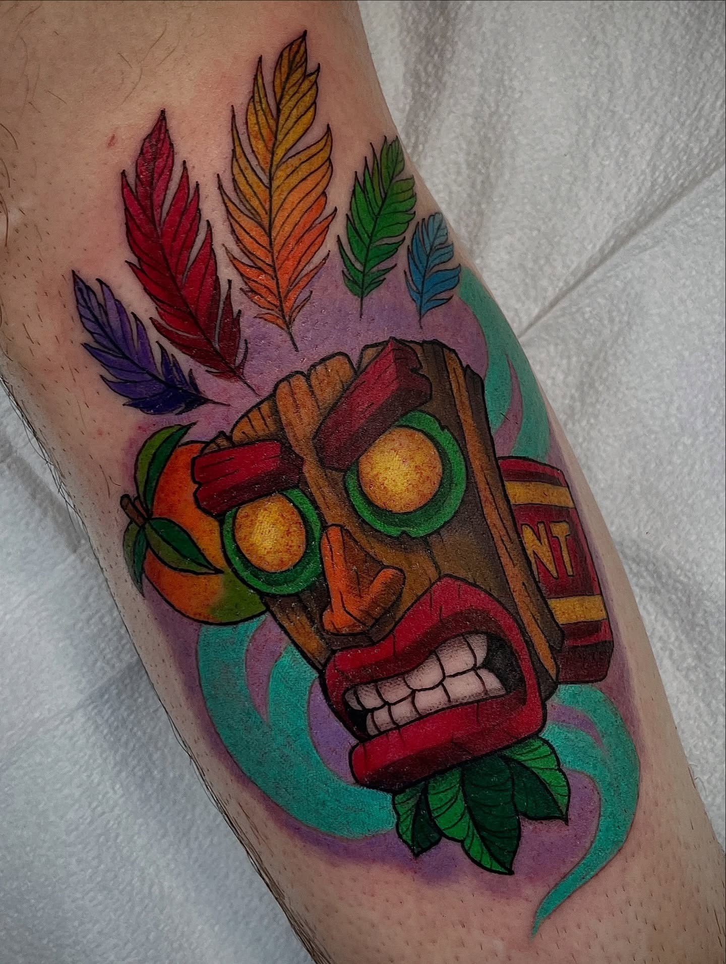 Tiki mask American traditional tattoo on the forearm by Kathryn the Tooth Collector