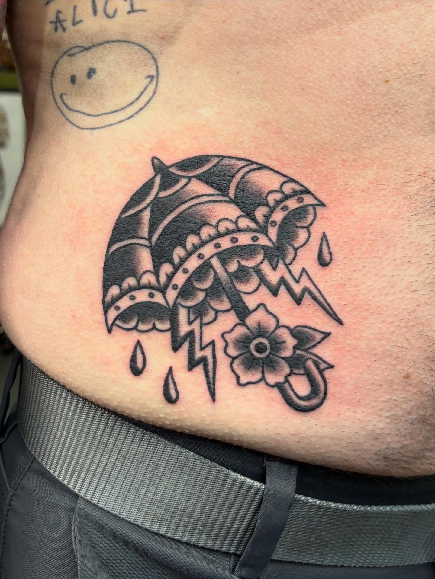 Umbrella and flower black and grey tattoo by Jamie Yuu, Minneapolis, Minnesota