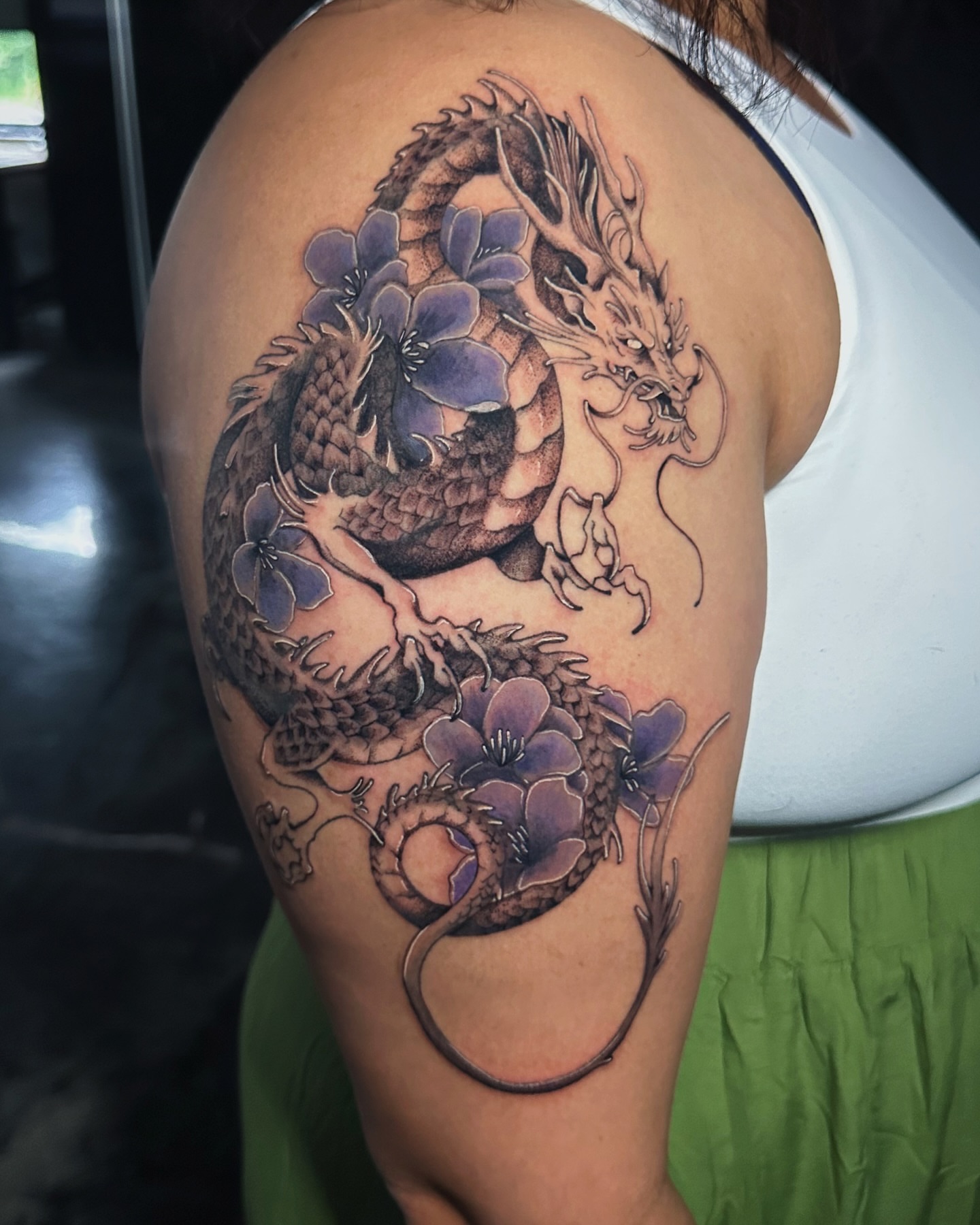 Dragon and flowers japanese irezumi tattoo on the shoulder by Kelsey Zussman