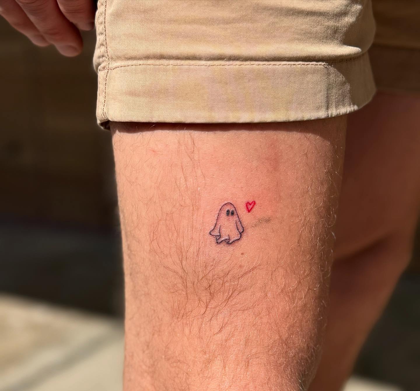 Ghost minimalist tattoo on the leg by Kylee Snow