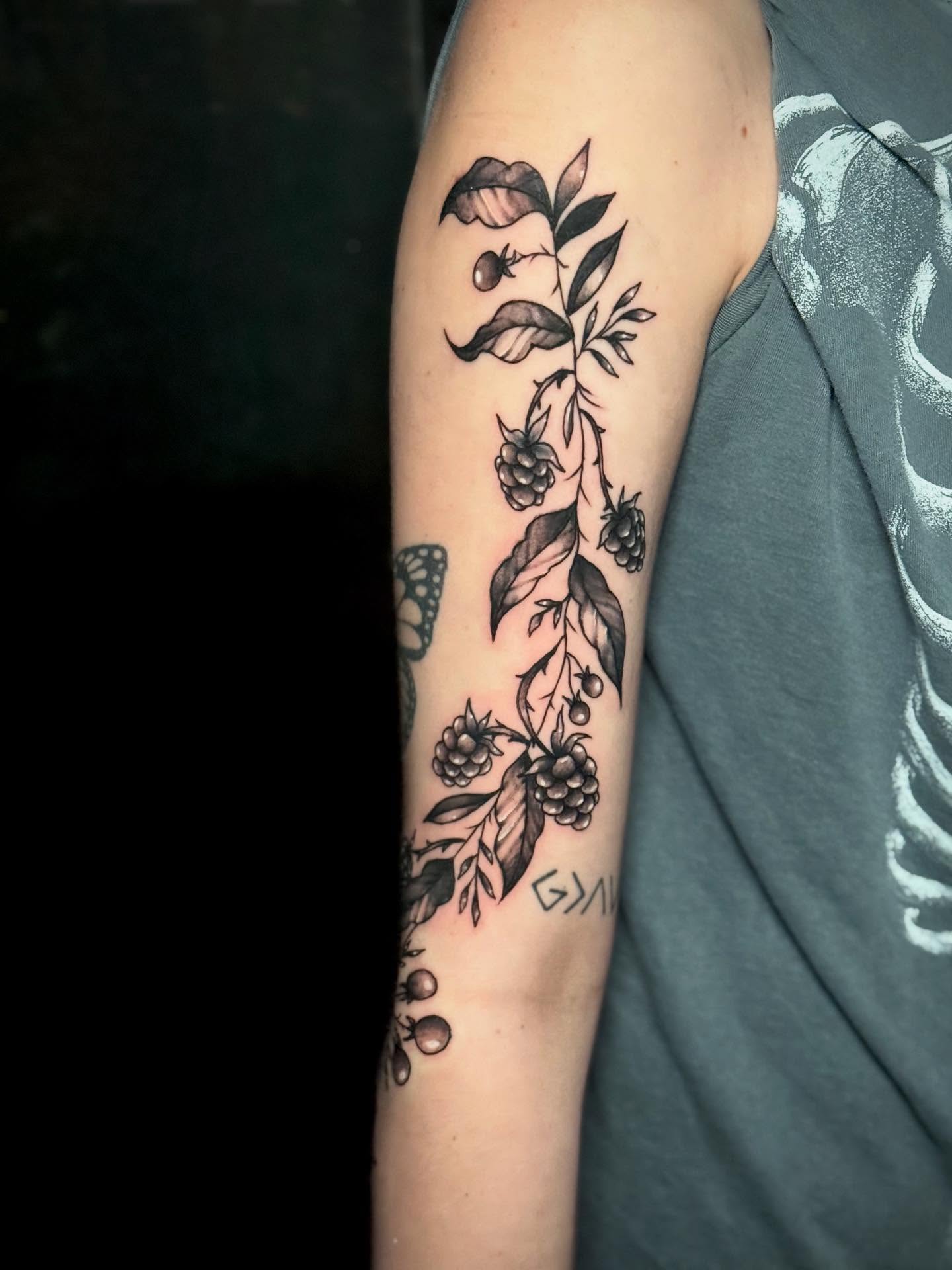 Berry vine black and grey tattoo on the forearm by Jeremy Carson