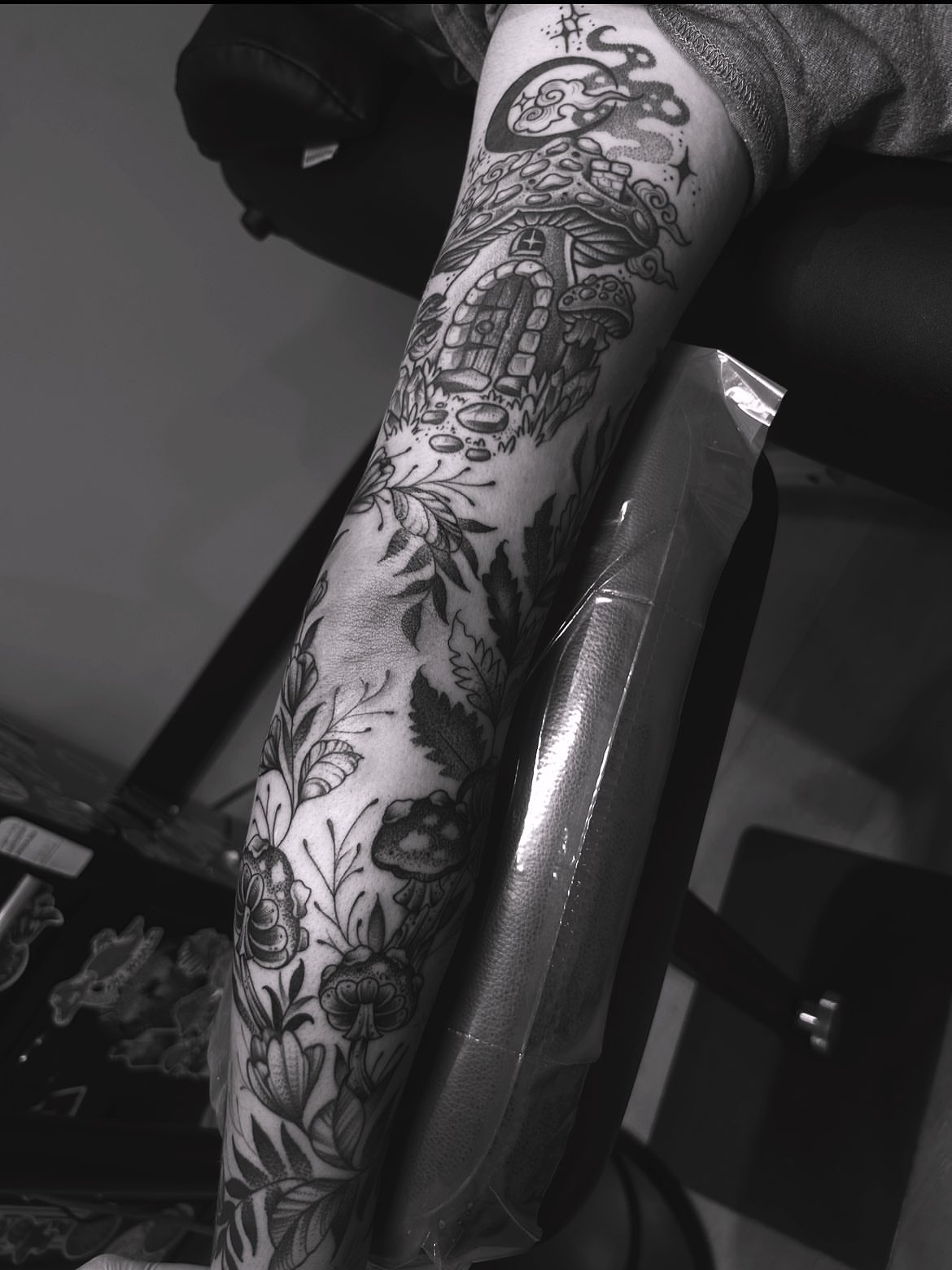 Mushroom house black and grey tattoo on the forearm by Anna Nicole Thomas