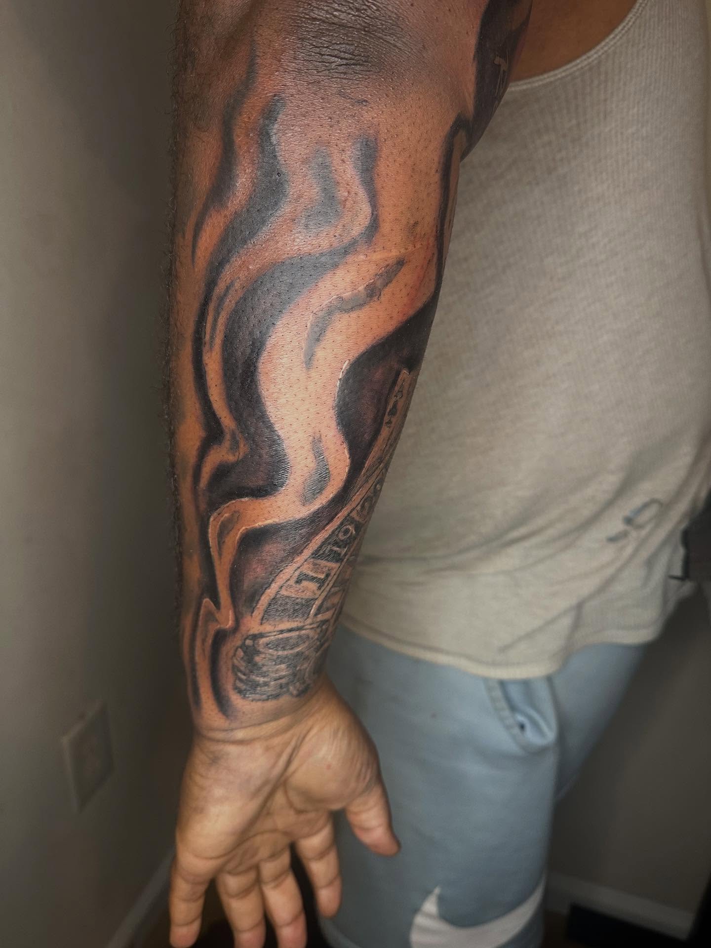 Flame black and grey tattoo on the forearm by Illuminink.gallery