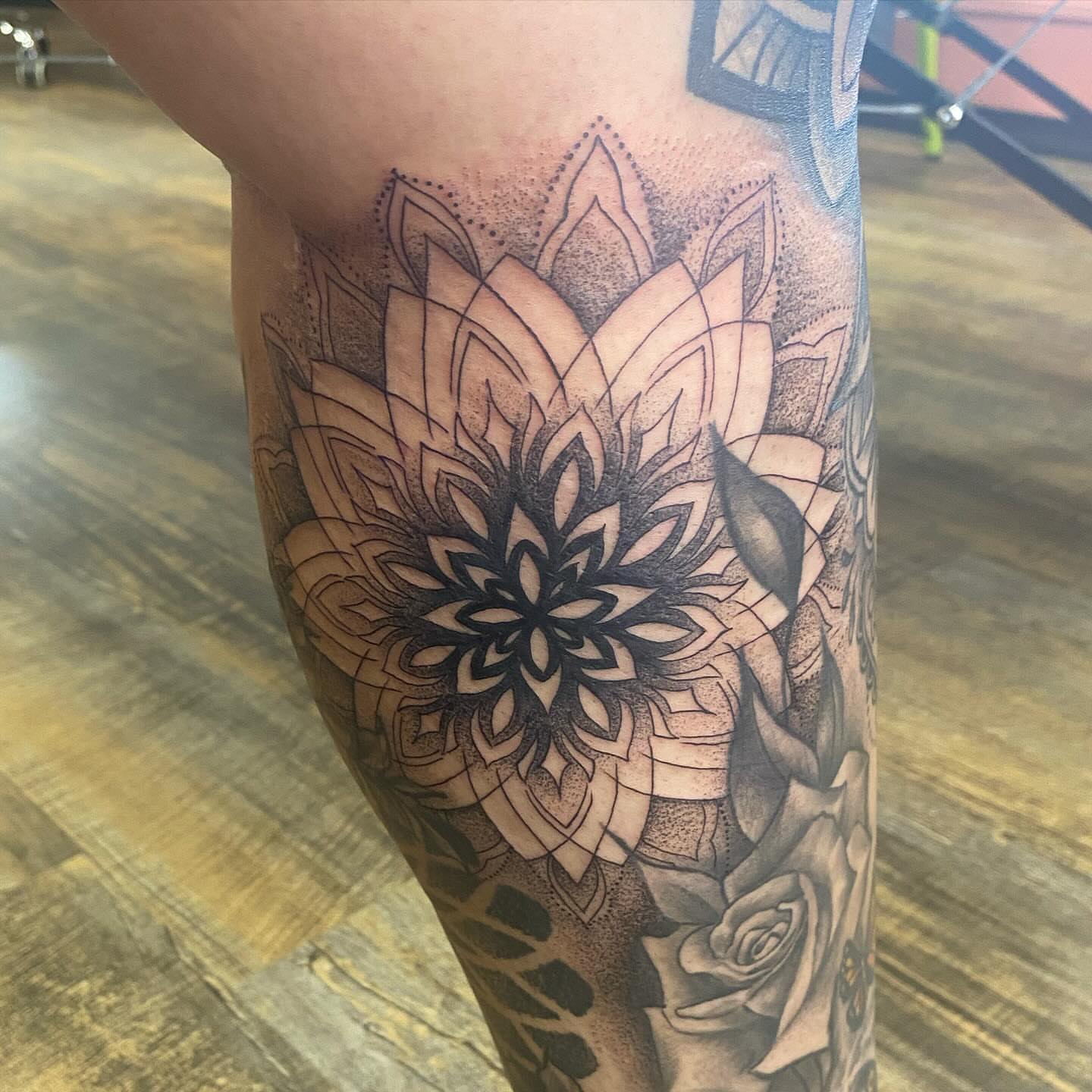 Lotus flower dotwork tattoo on the calf by Casey Dohner