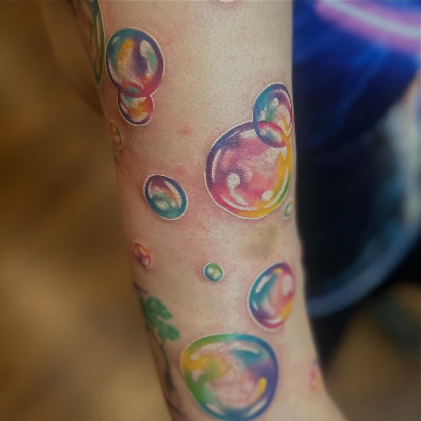Soap bubbles watercolor tattoo on the forearm by Megan Sierra