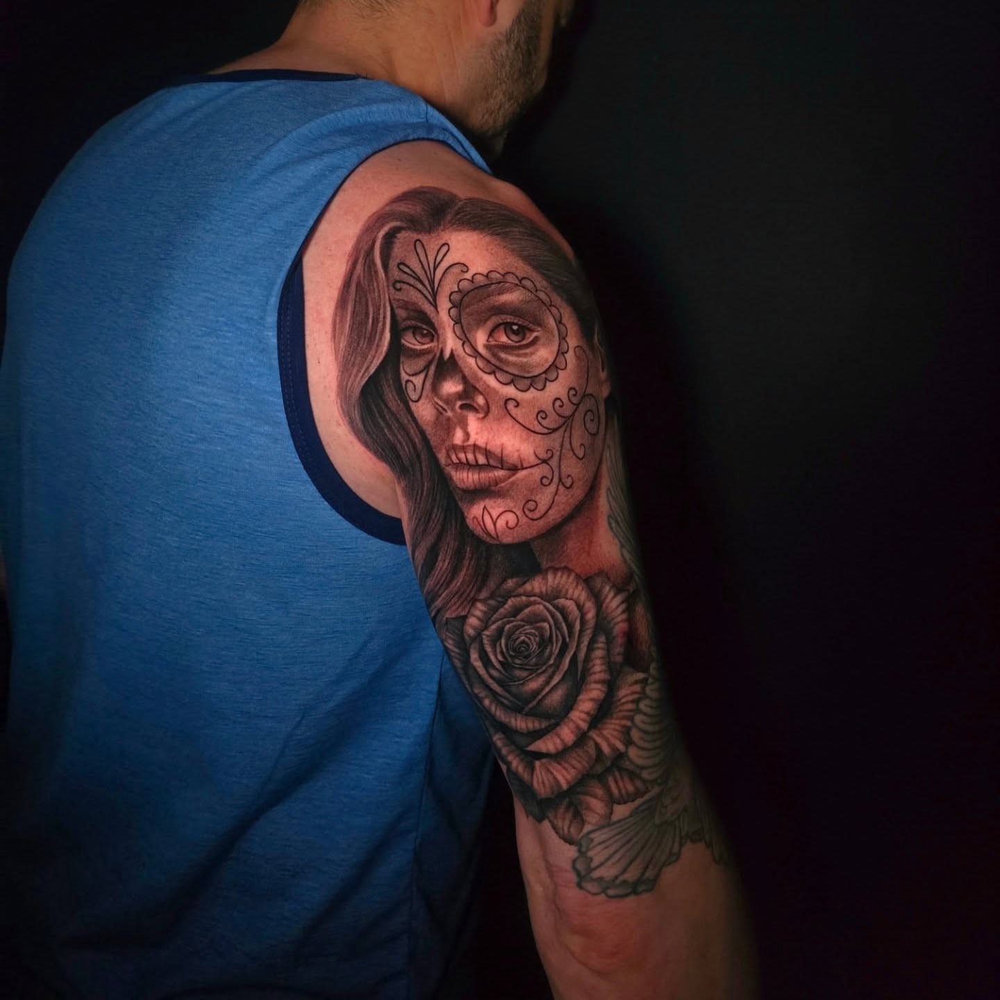 Sugar skull realism tattoo on the upper arm by Anna Brittany
