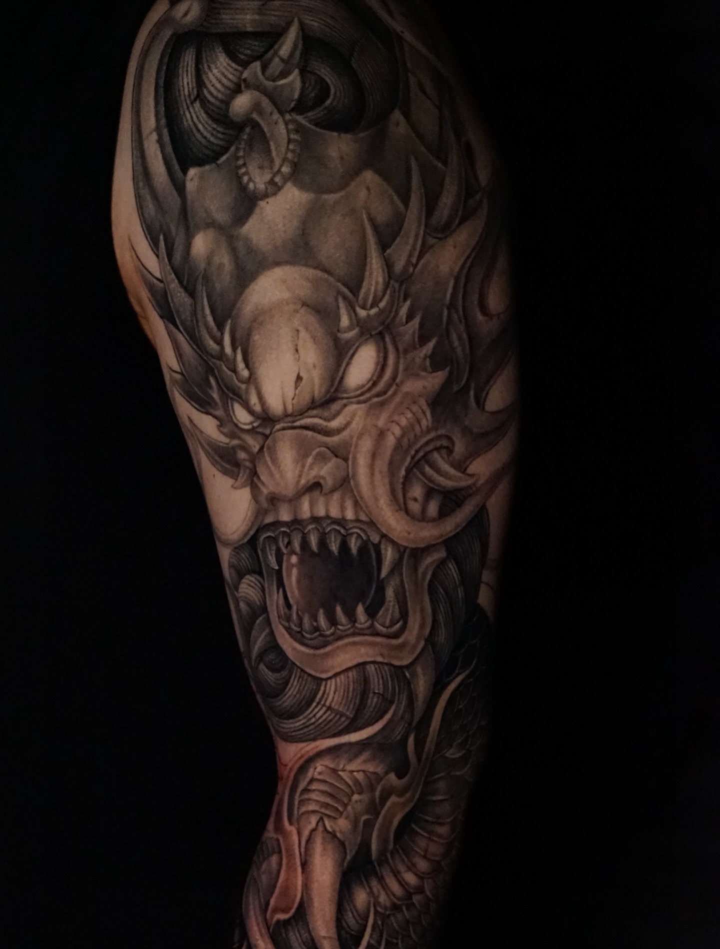 Demon dark realism tattoo on the forearm by Anh Nguyen