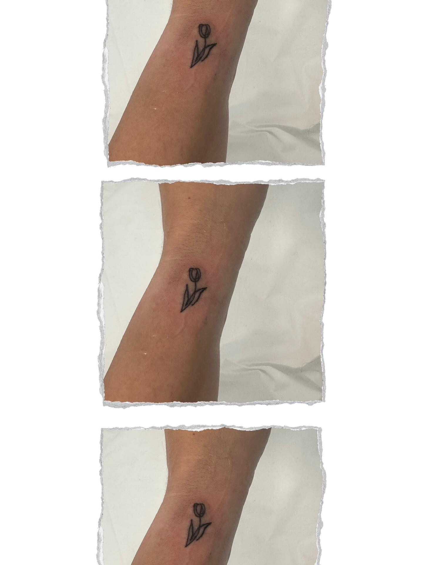 Tulip black and grey tattoo on the forearm by Victoria Cooper