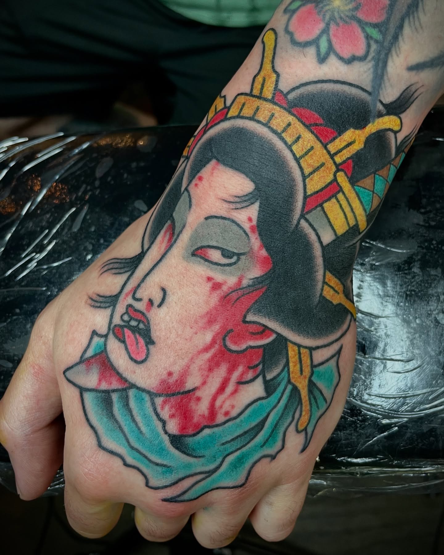 Geisha head American traditional tattoo on the hand by Tom Taylor, Philadelphia, Pennsylvania