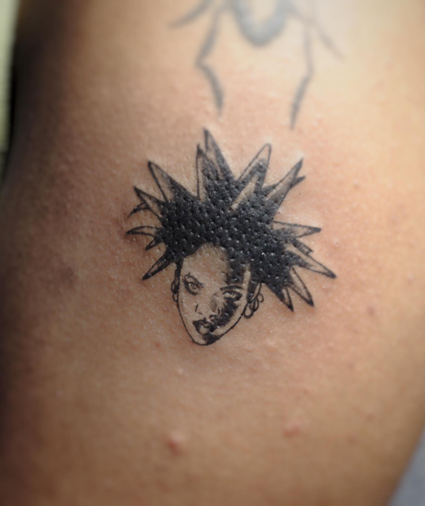 Spiky hair dotwork tattoo on the thigh by Bek Artz