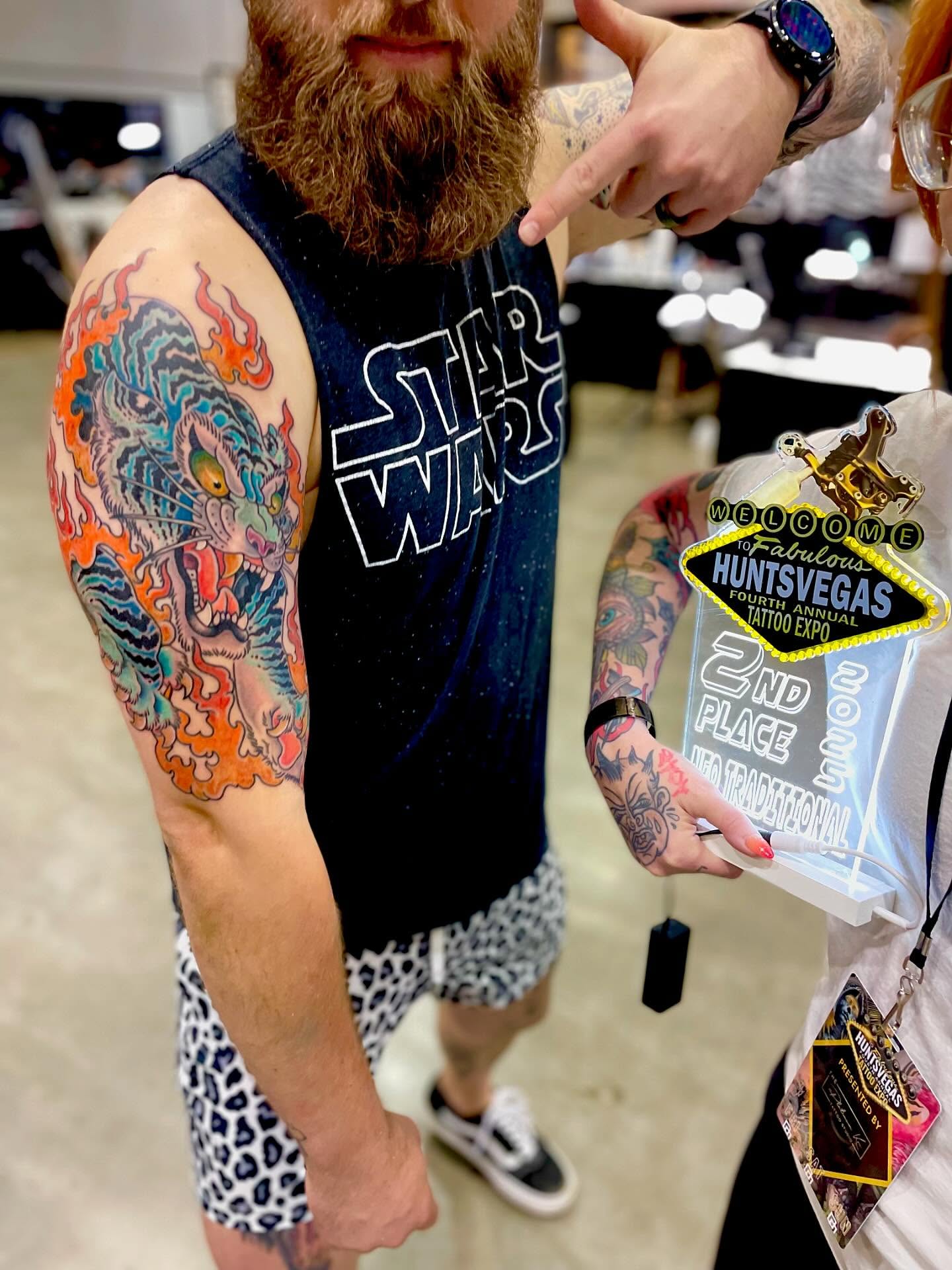 Flame tiger American traditional tattoo on the forearm by Jessi Kilpatrick