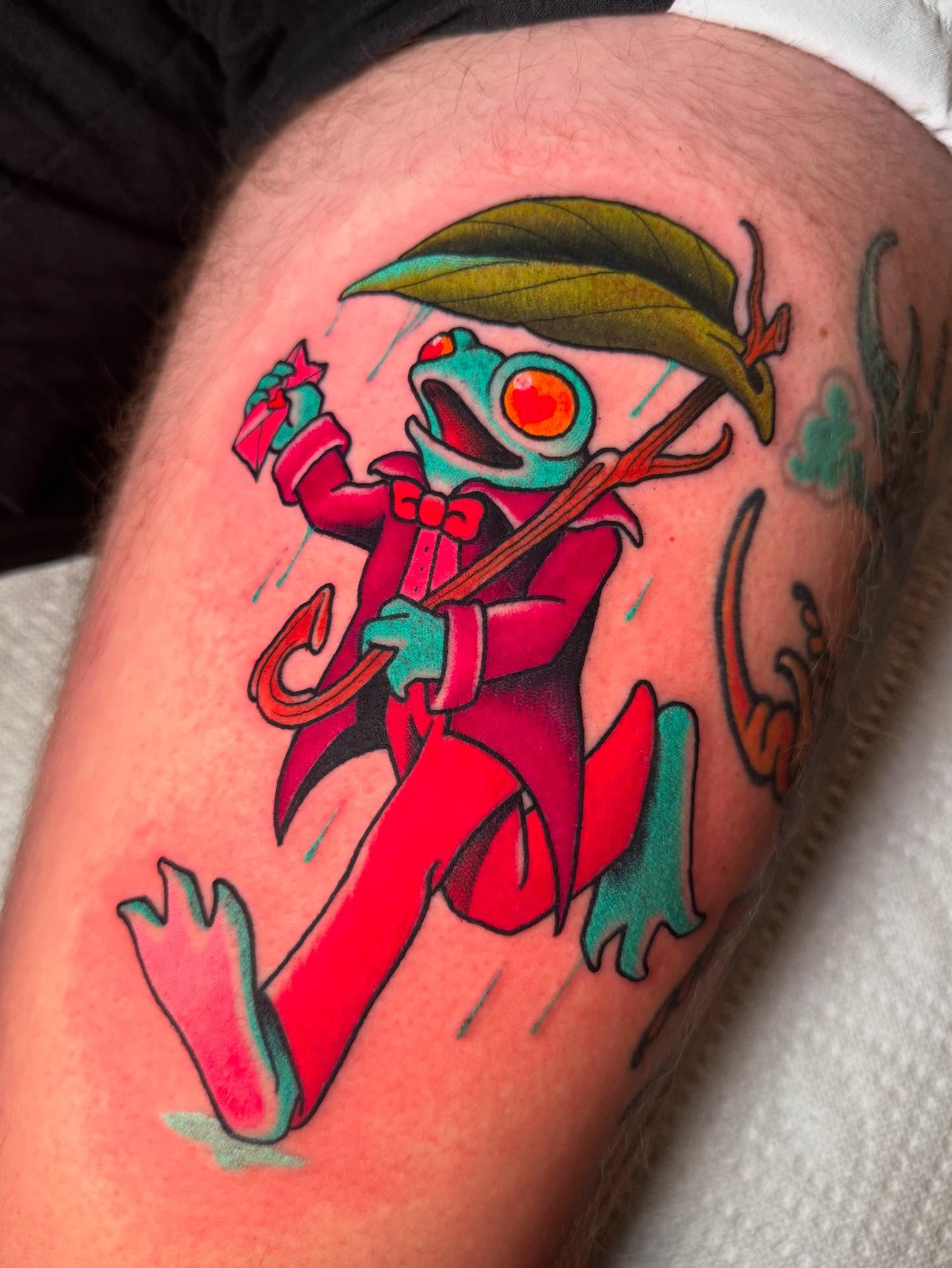 Frog in red suit new school tattoo on the thigh by Jess Longfield, Des Moines, Iowa