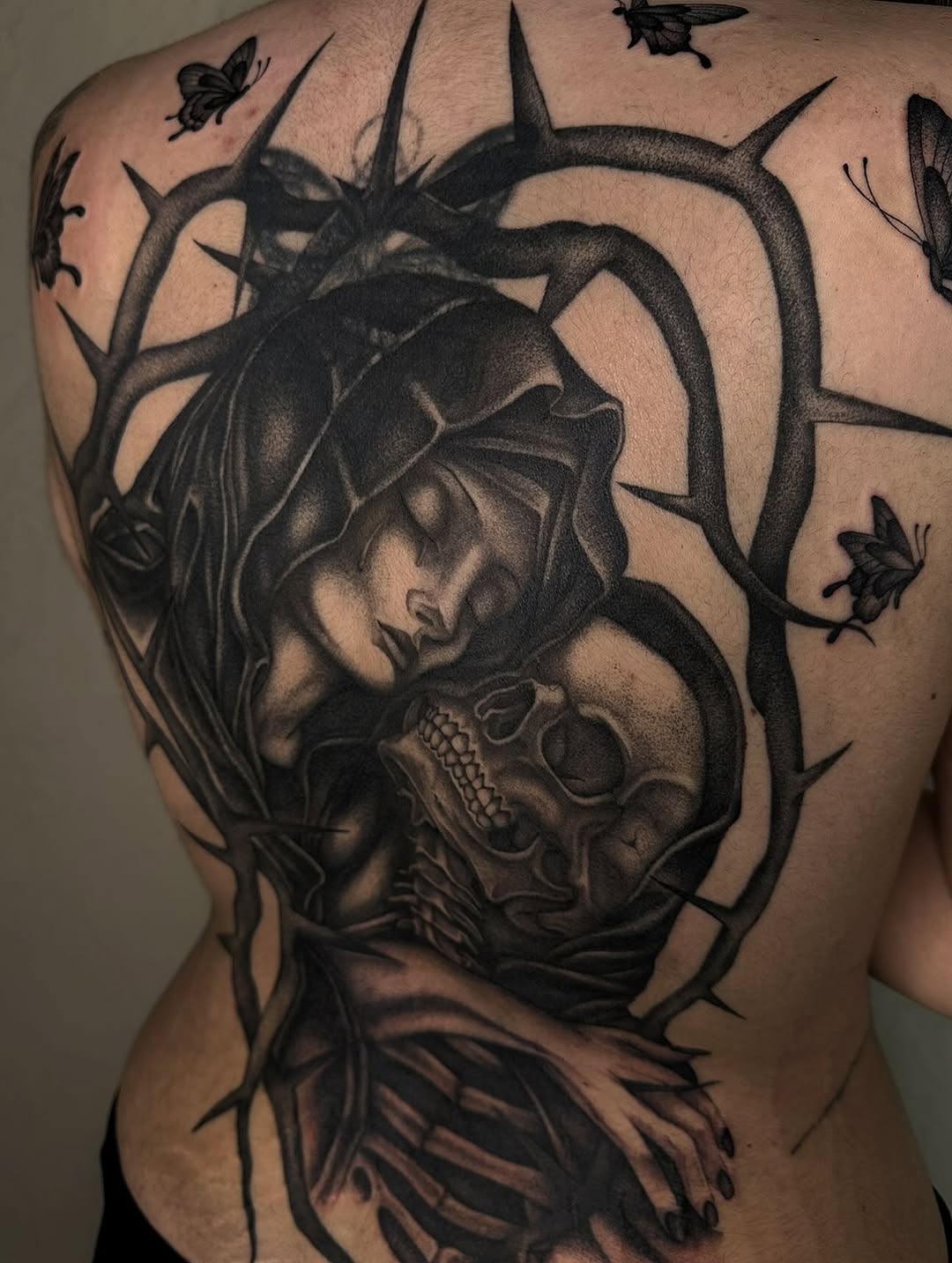 Woman embracing a skull realism tattoo on the back by 𝖍𝖆𝖓𝖓𝖆𝖍