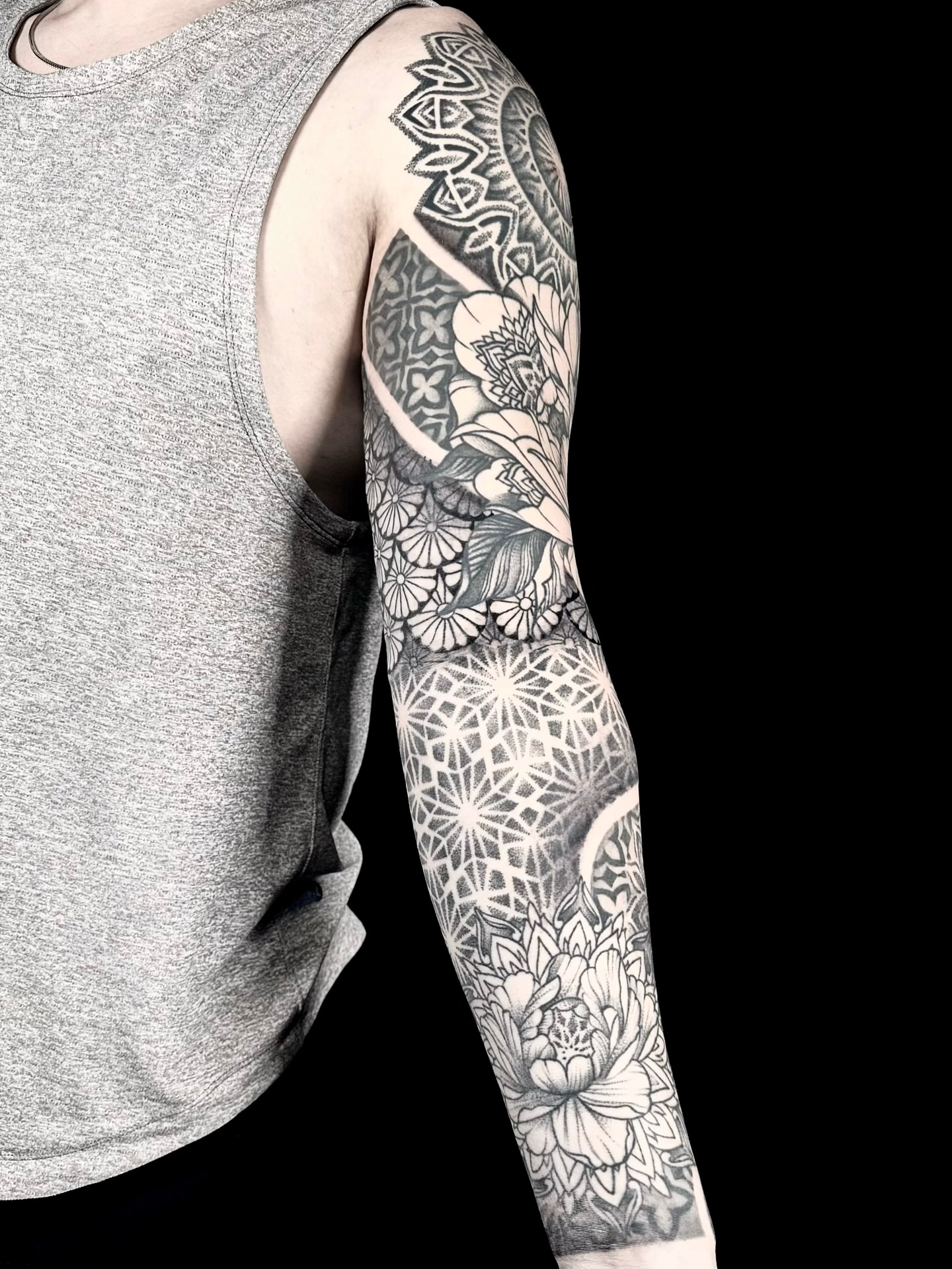 Floral mandala geometric tattoo on the upper arm by Abi