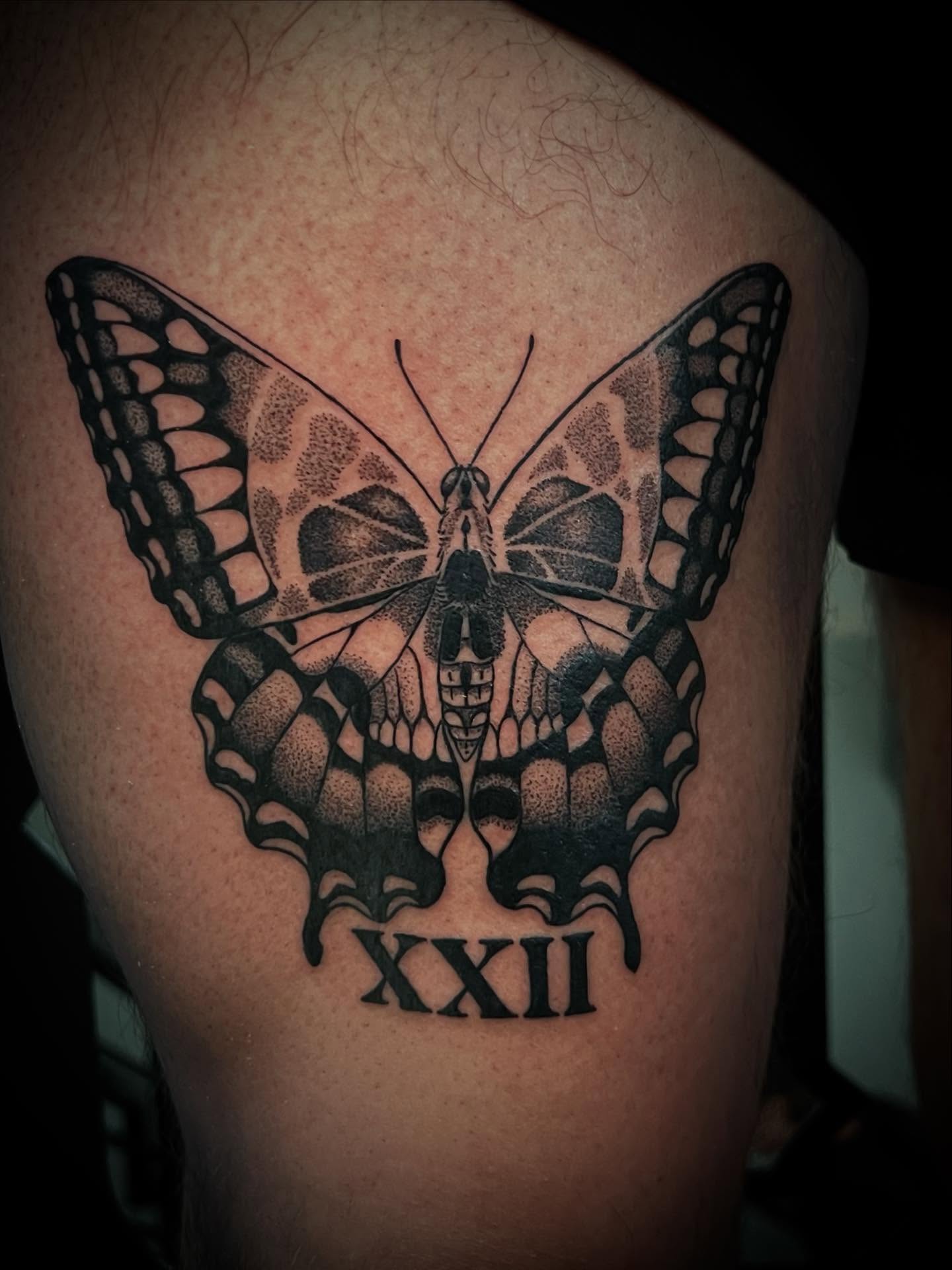 Butterfly dotwork tattoo on the thigh by Keith Goble